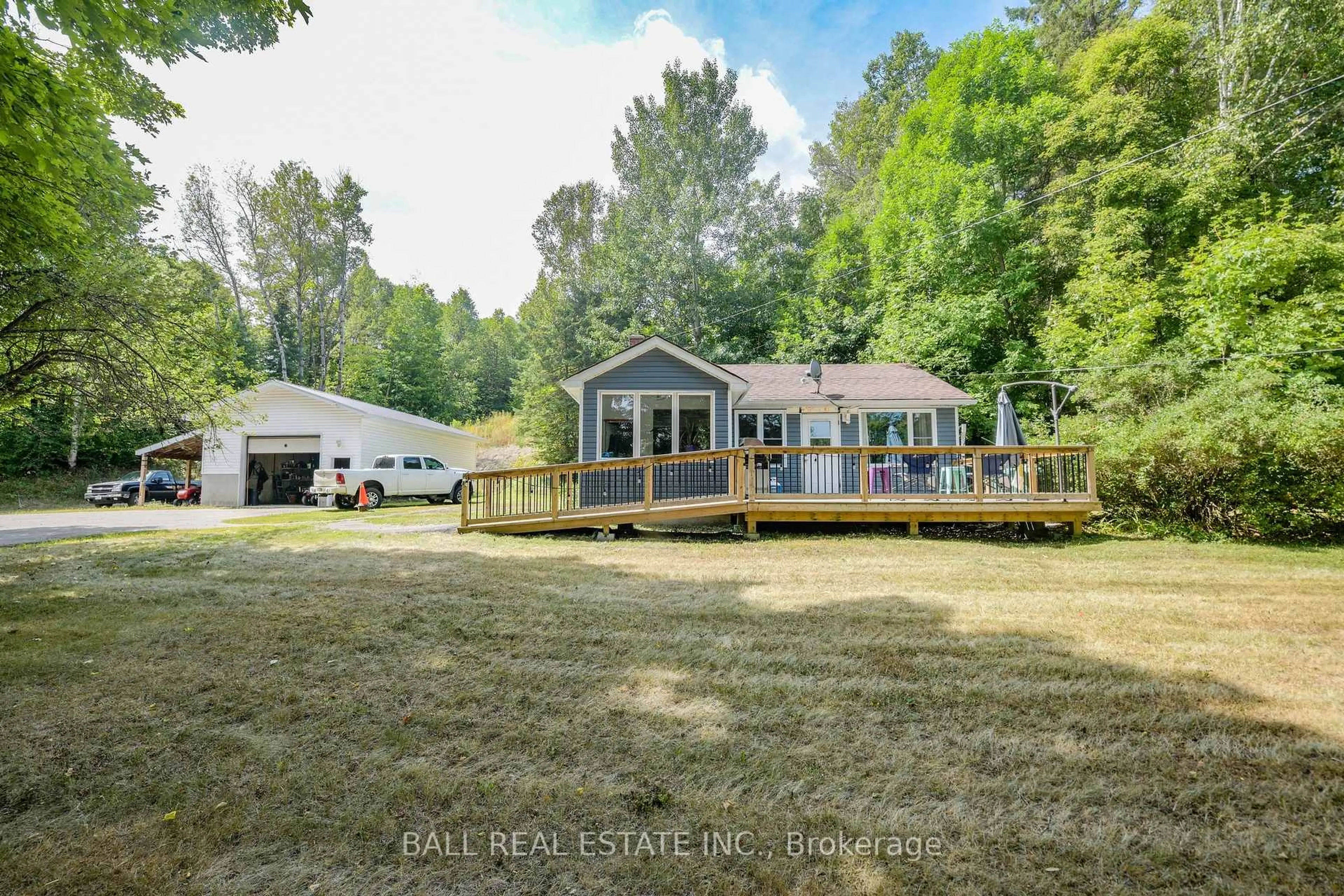 A pic from outside/outdoor area/front of a property/back of a property/a pic from drone, water/lake/river/ocean view for 23104 Hwy 118 Highway, Highlands East Ontario K0L 1M0