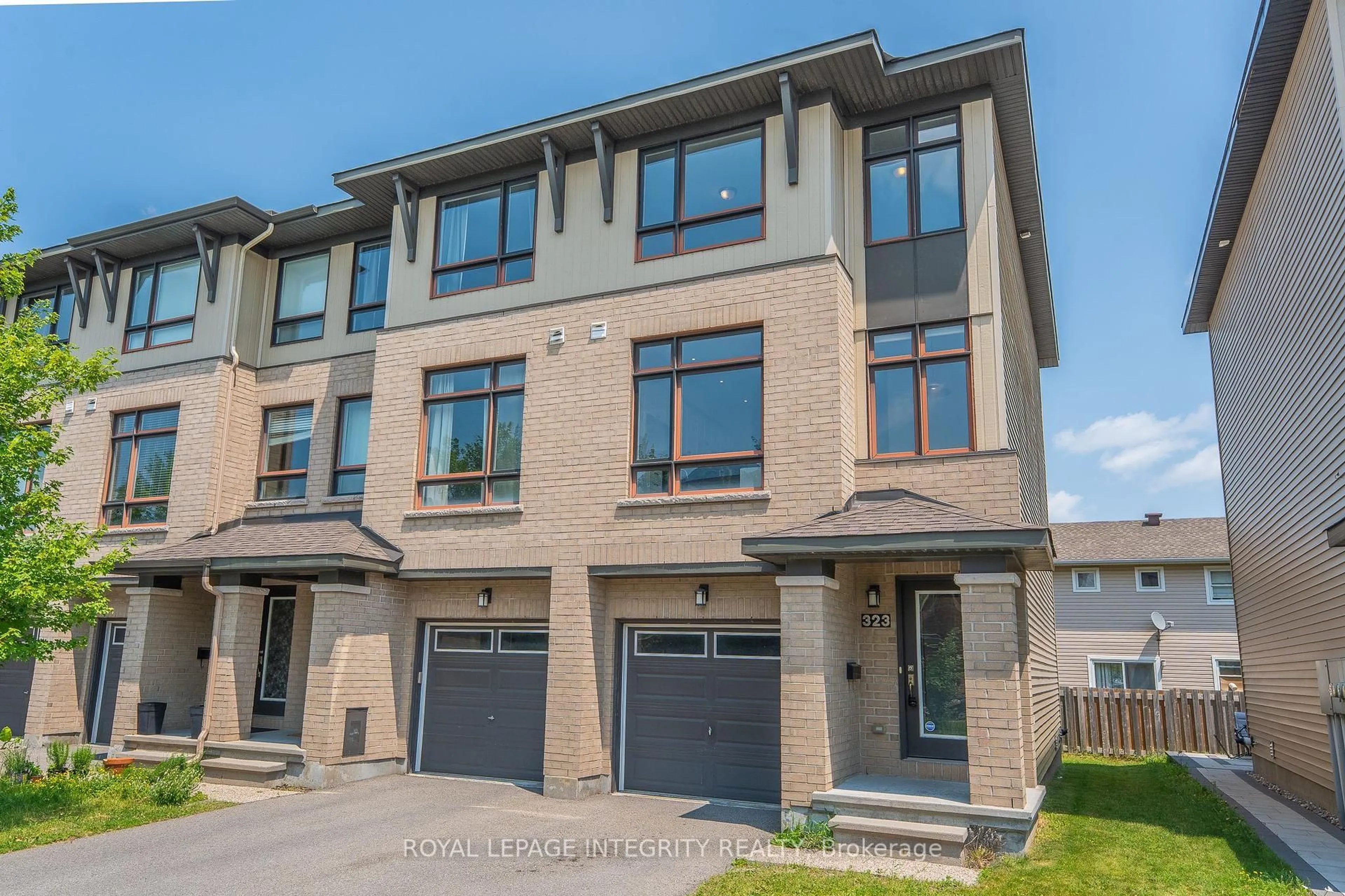 Home with brick exterior material, street for 323 Twinflower Way, Ottawa Ontario K2J 5Z6