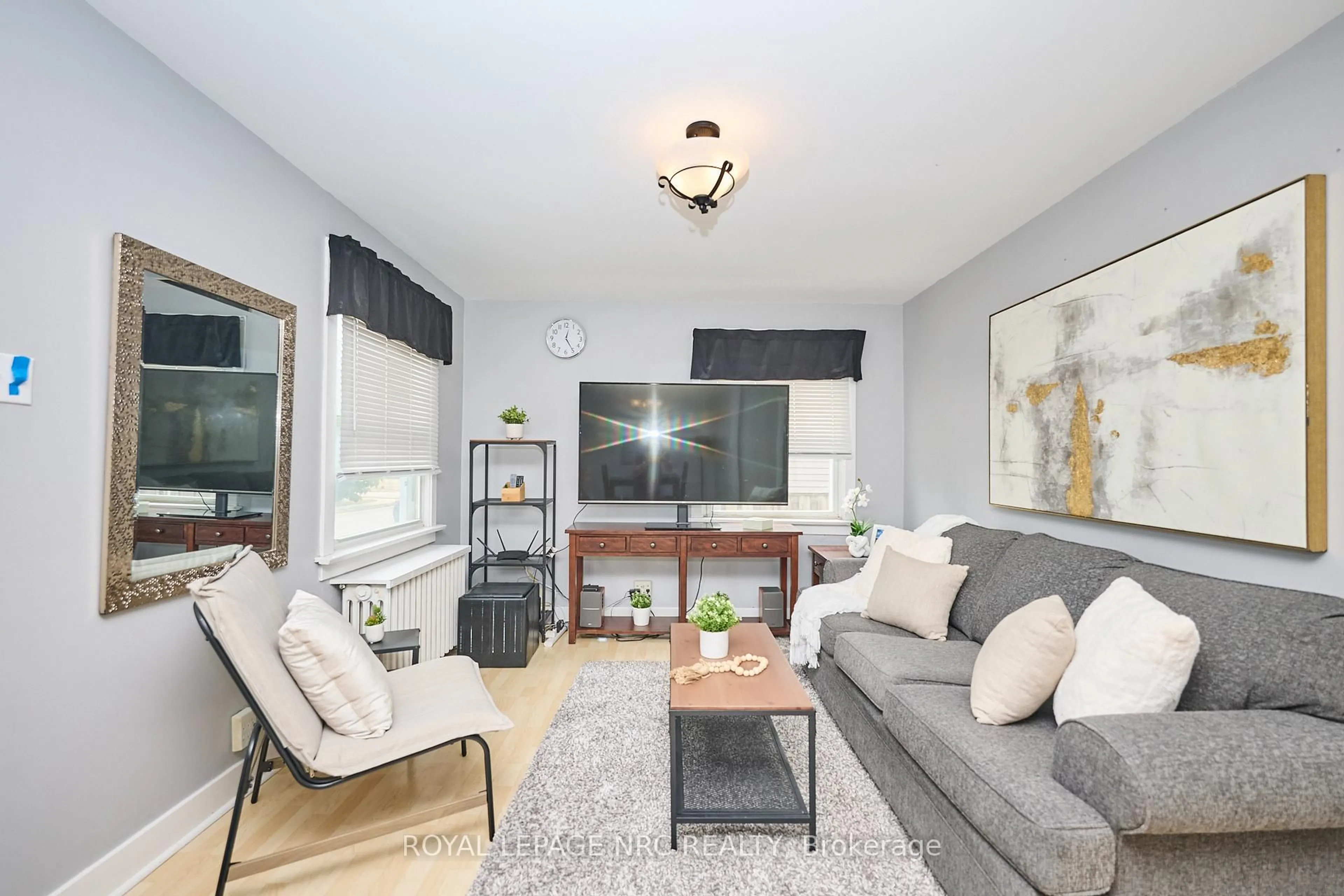 Living room with furniture, wood/laminate floor for 8 Woodburn Ave, St. Catharines Ontario L2P 2W7