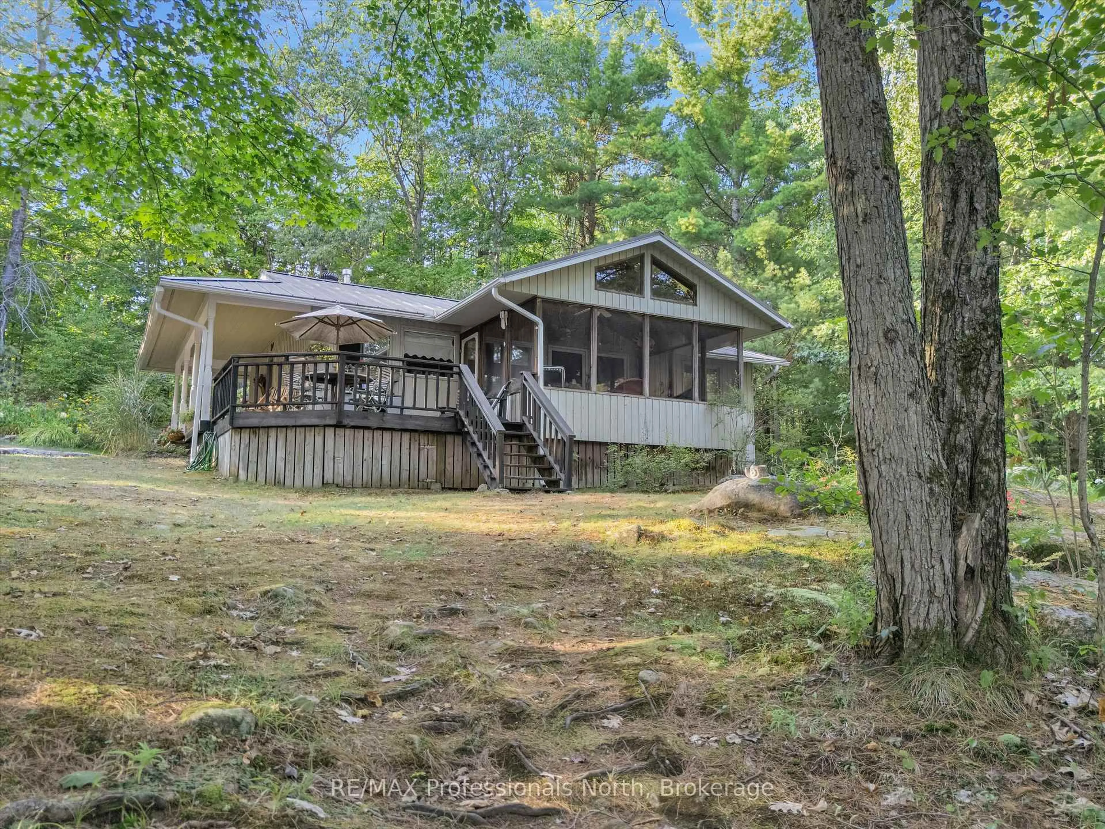 A pic from outside/outdoor area/front of a property/back of a property/a pic from drone, forest/trees view for 1401 Rocksborough Road Pvt 2, Bracebridge Ontario P1L 1X3