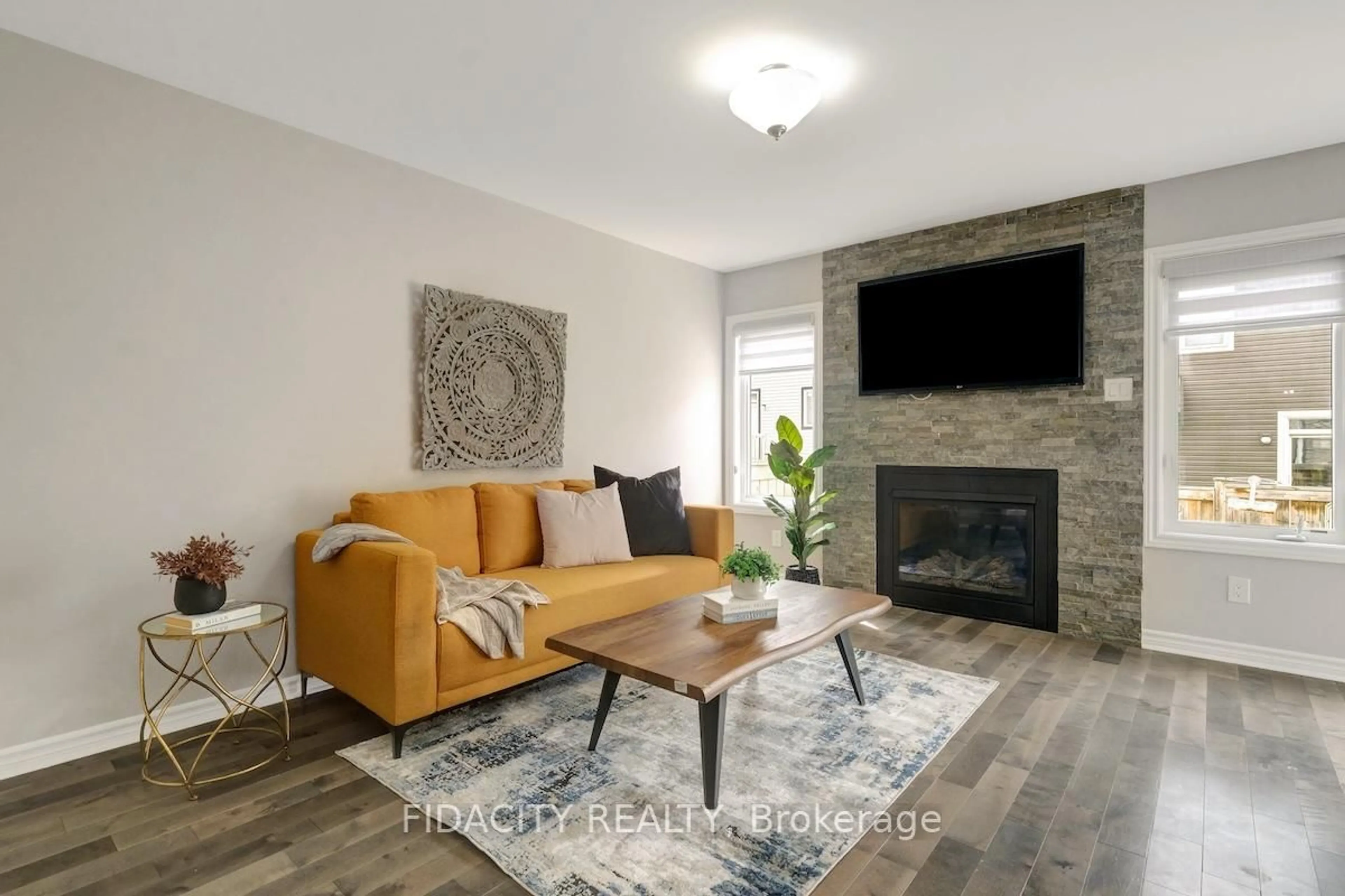 Living room with furniture, wood/laminate floor for 525 Foxlight Circ, Ottawa Ontario K2M 0L9