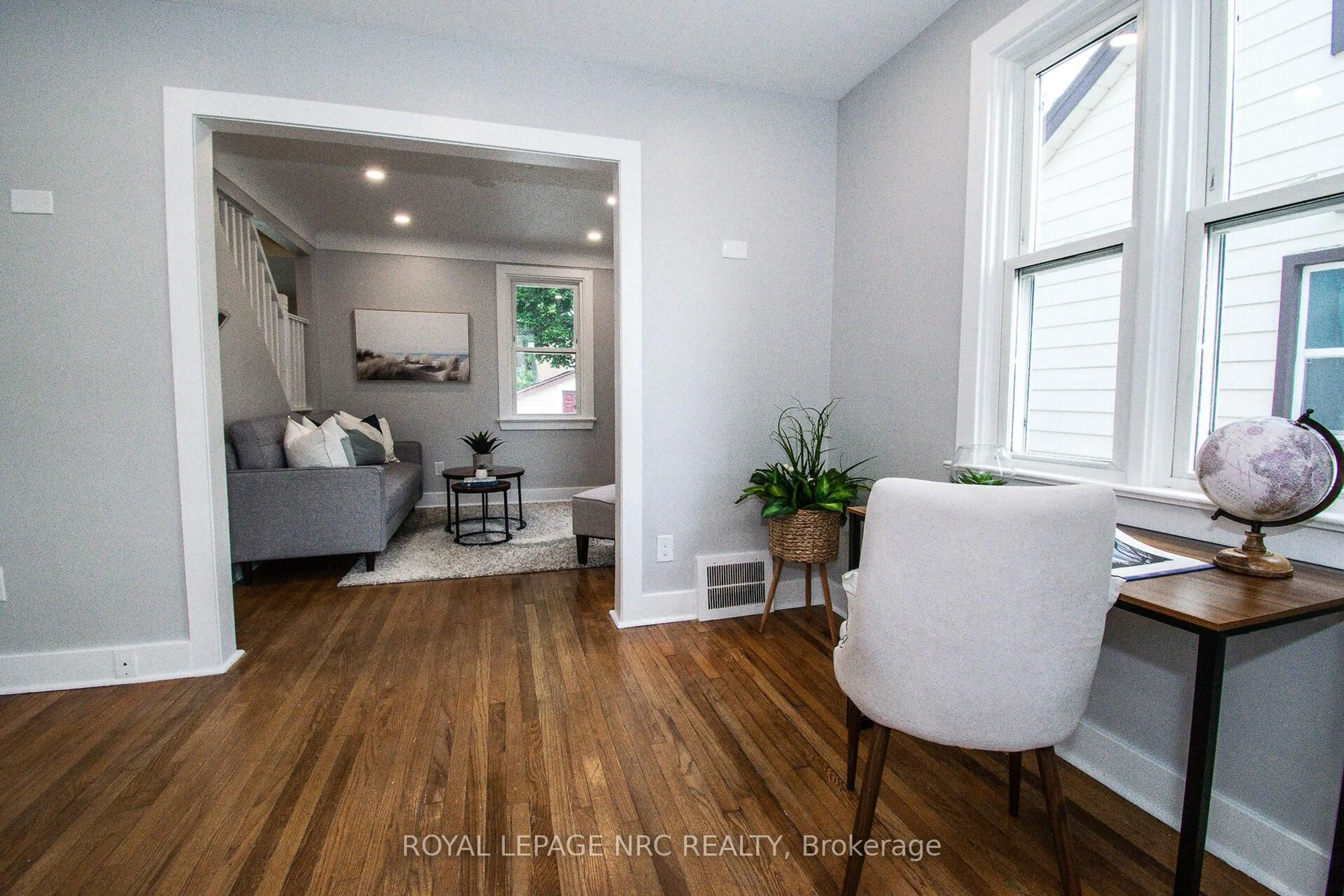 Living room with furniture, wood/laminate floor for 57 Hamilton St, St. Catharines Ontario L2S 1K8