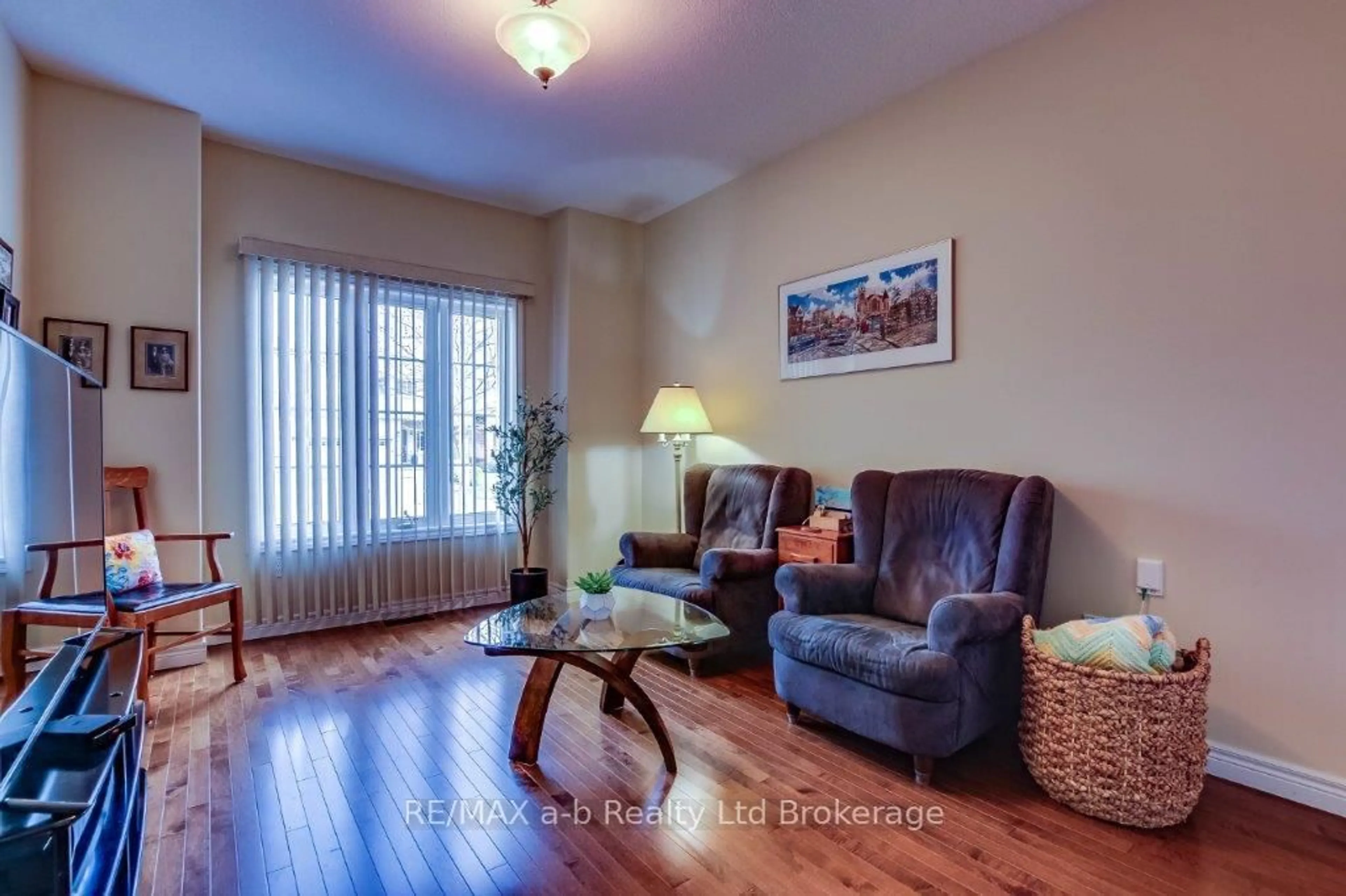 Living room with furniture, wood/laminate floor for 717 Garden Court Cres, Woodstock Ontario N4T 0A2