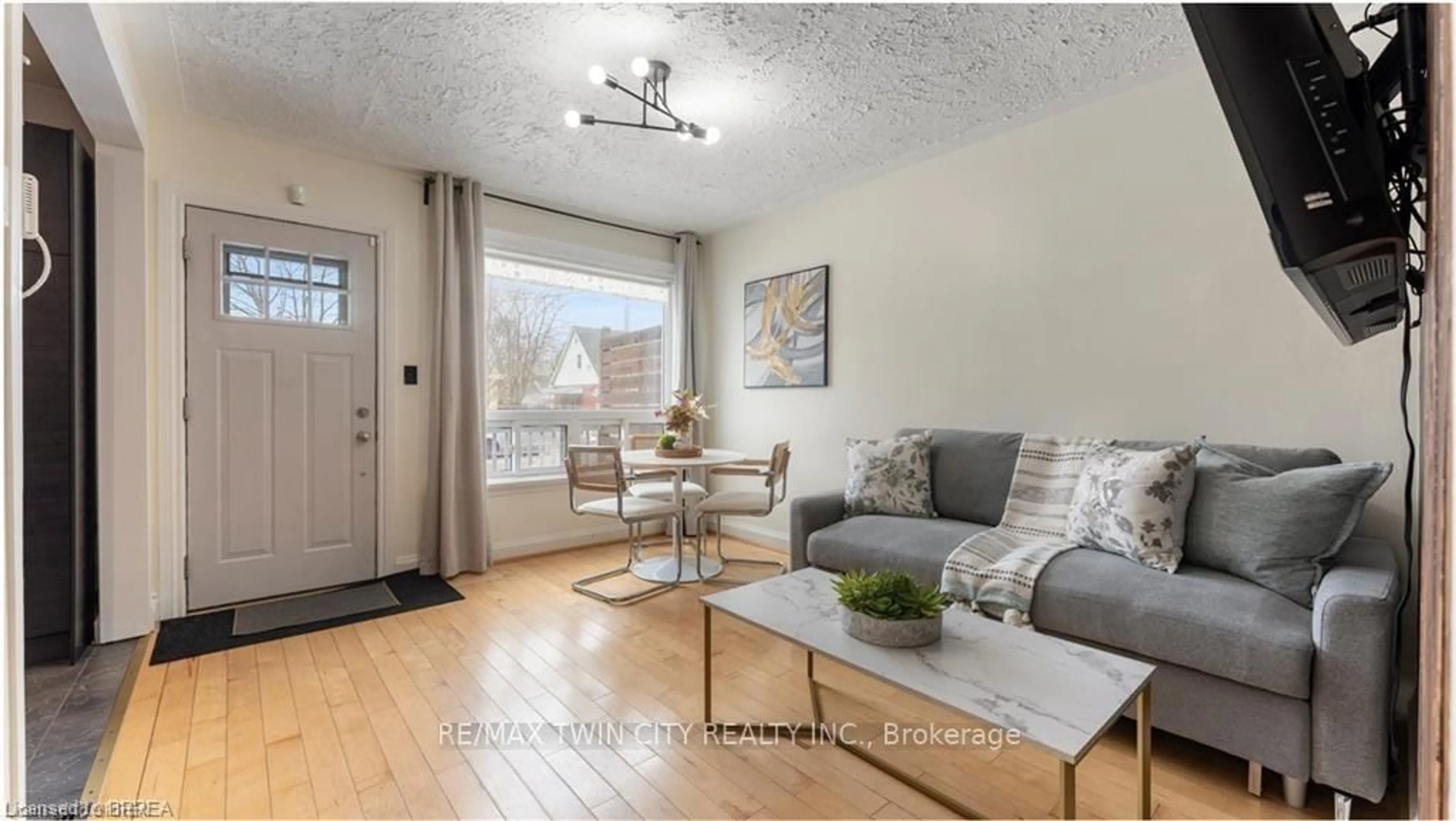 Living room with furniture, wood/laminate floor for 69 Lyons Ave, Brantford Ontario N3R 4R2