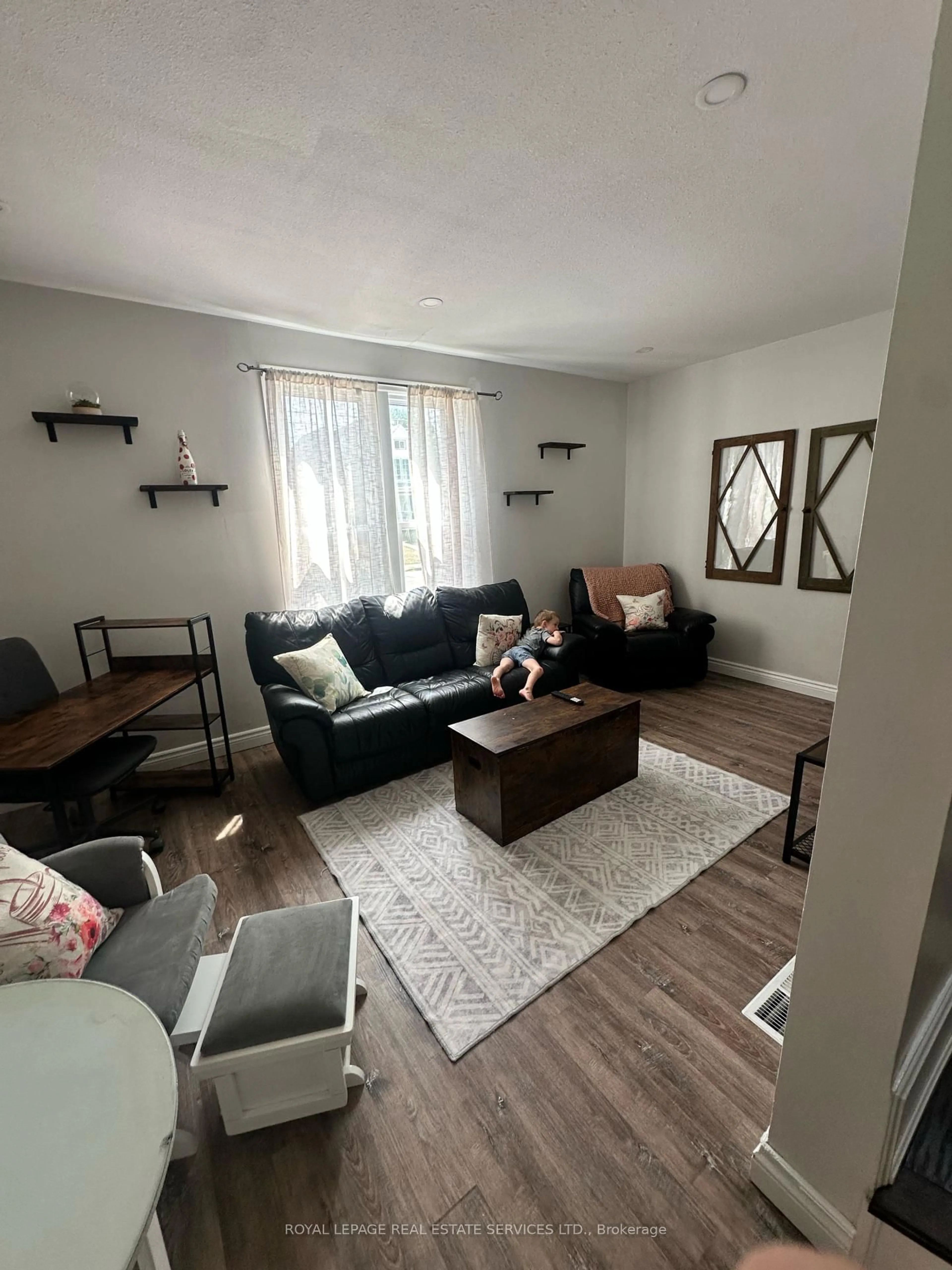 Living room with furniture, wood/laminate floor for 4347 Simcoe St, Niagara Falls Ontario L2E 1T5