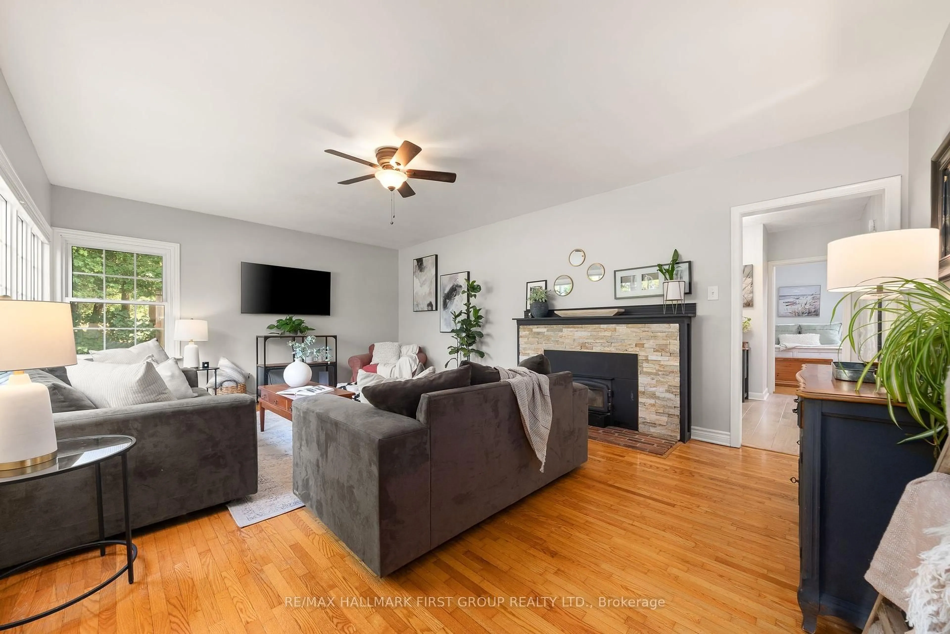 Living room with furniture, wood/laminate floor for 4073 Burnham St, Hamilton Township Ontario K9A 4J9