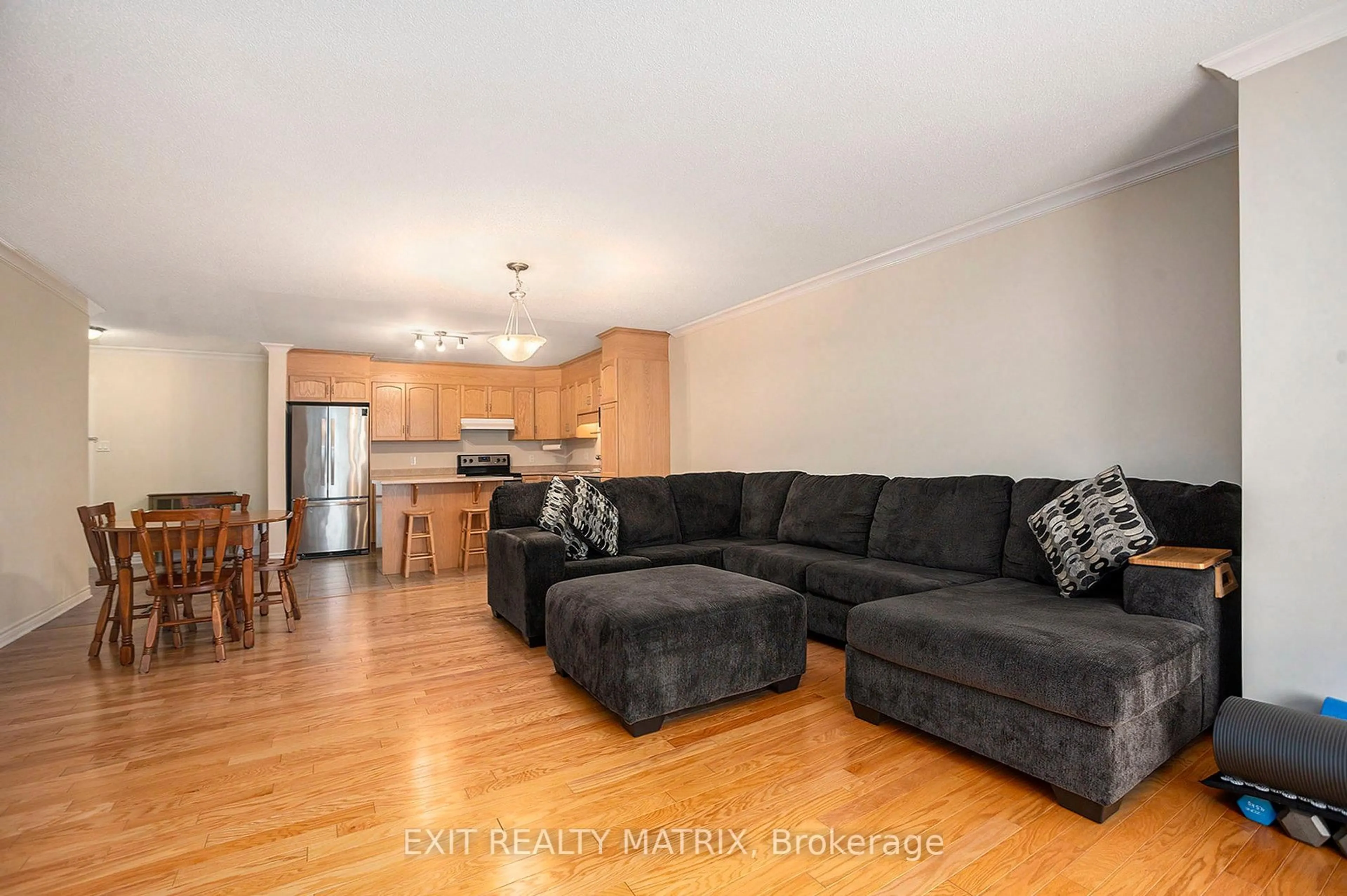 Living room with furniture, wood/laminate floor for 38 Charles St #206, North Stormont Ontario K0A 1R0