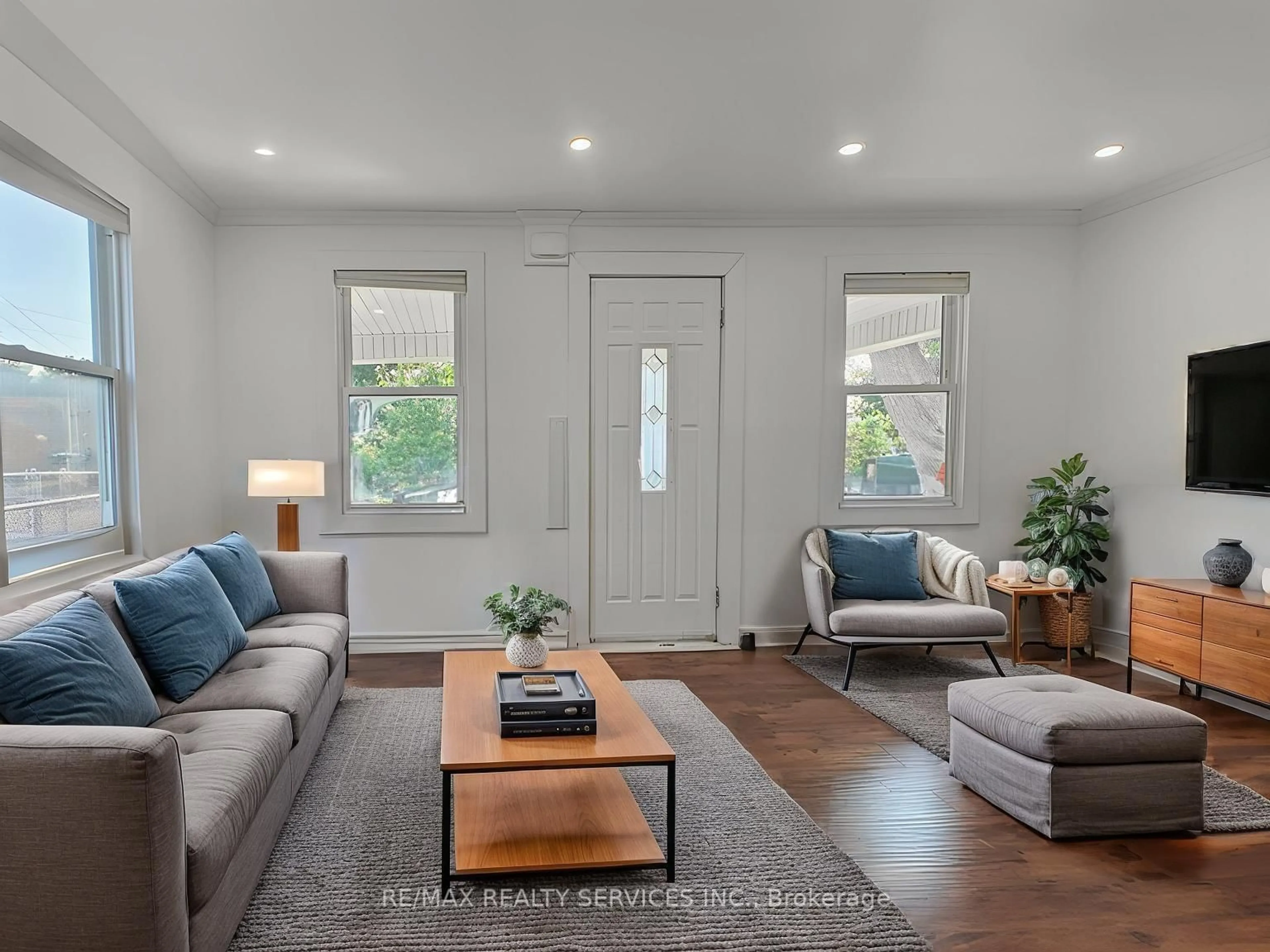 Living room with furniture, wood/laminate floor for 764 Caron Ave, Windsor Ontario N9A 5B6