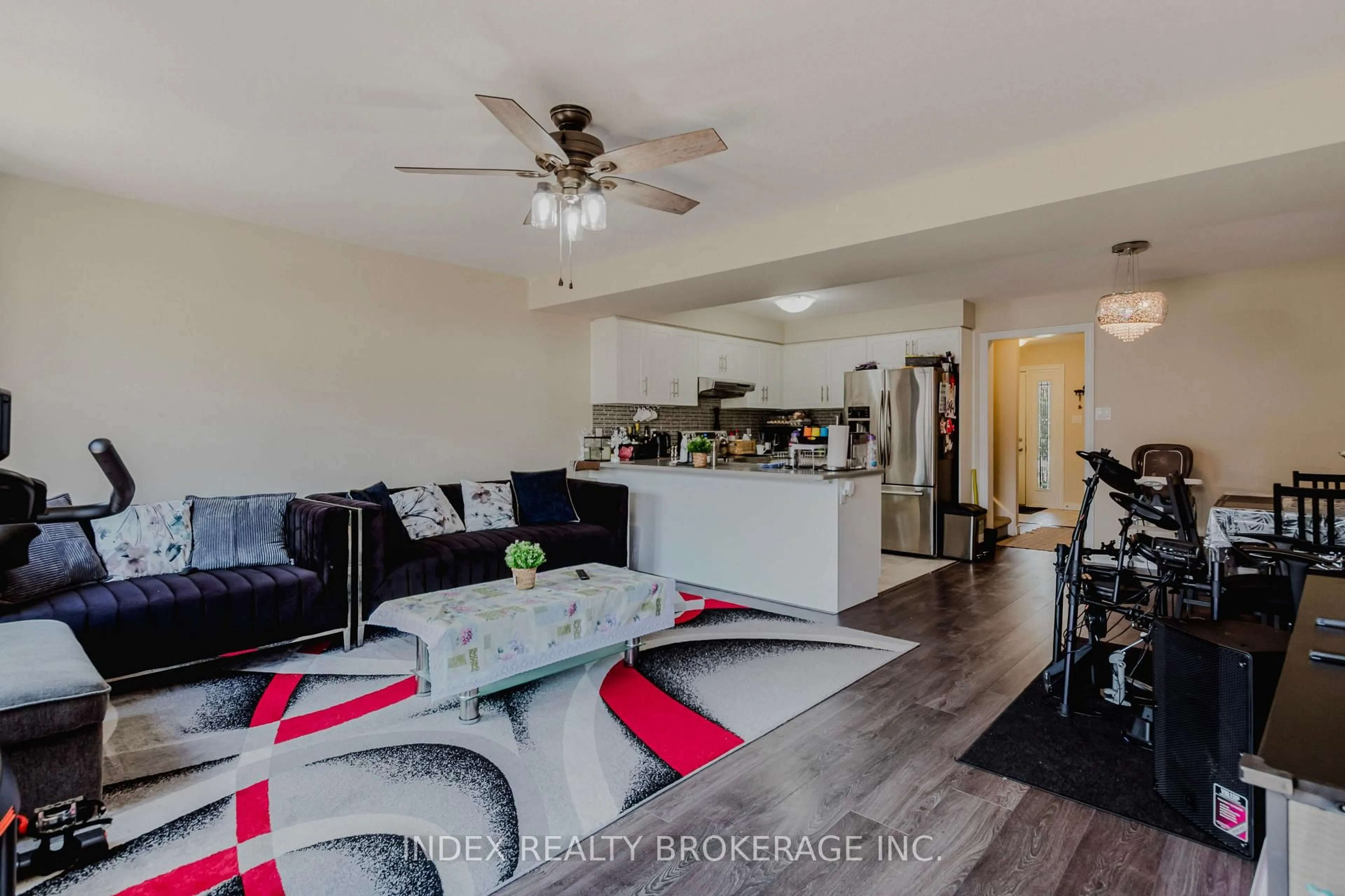 Living room with furniture, wood/laminate floor for 207 Eden Oak Tr, Kitchener Ontario N2A 0H6