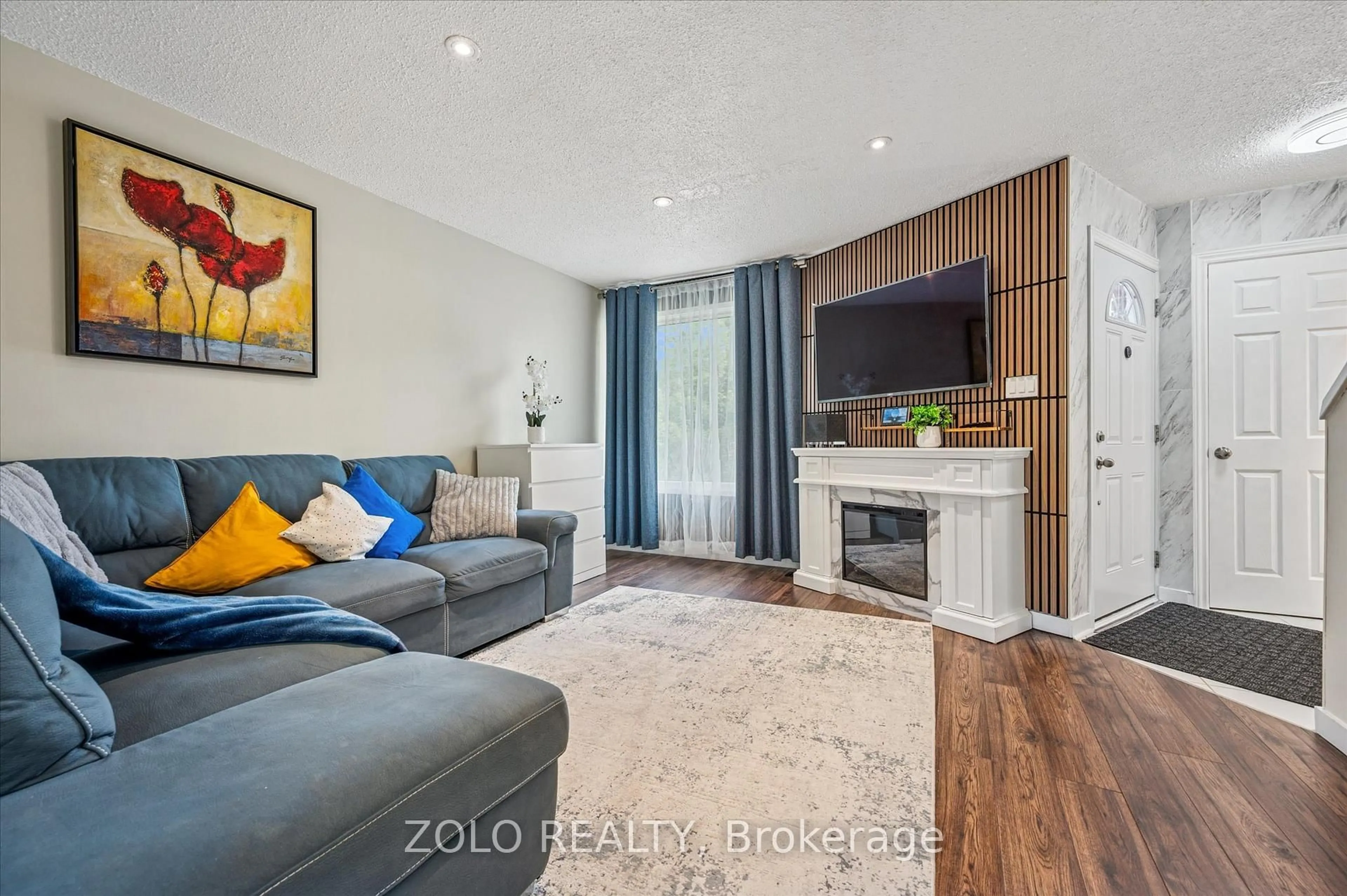 Living room with furniture, wood/laminate floor for 203 Fairway Rd N Rd #13, Out of Area Ontario N2A 2N7