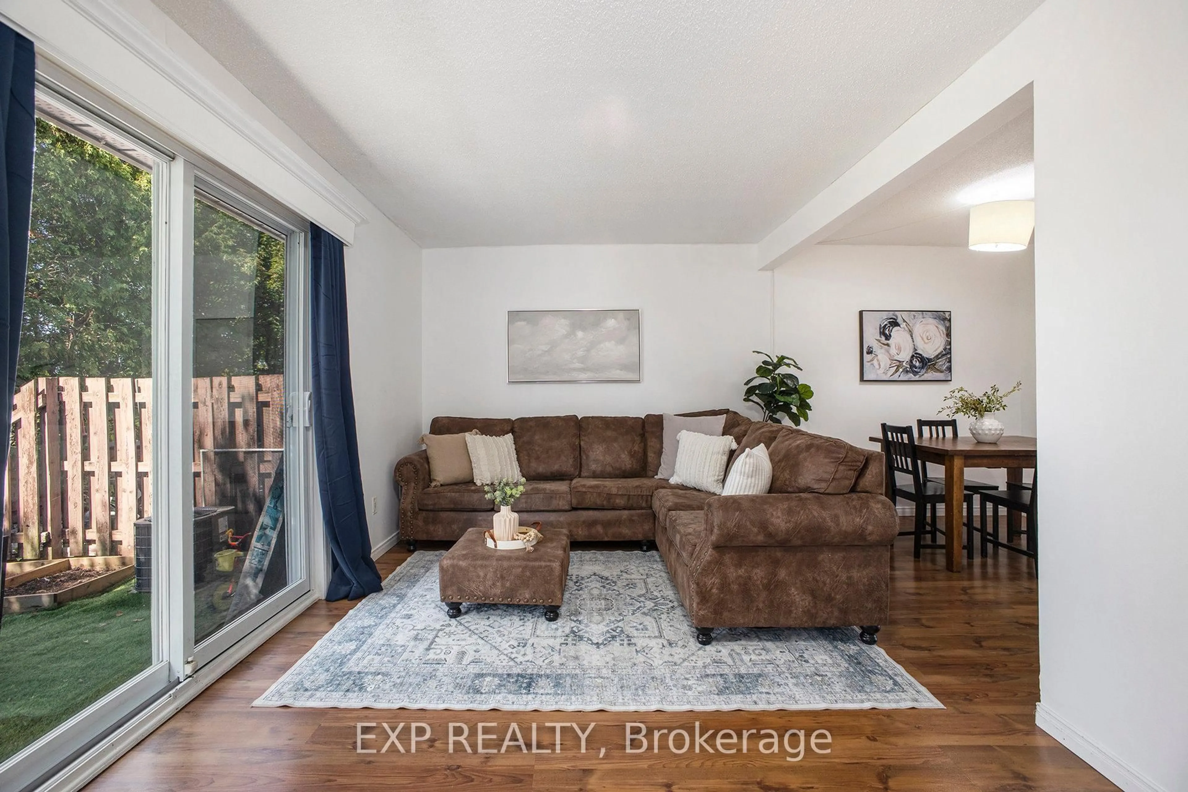 Living room with furniture, wood/laminate floor for 30 Baneberry Cres #68, Ottawa Ontario K2L 2Y4