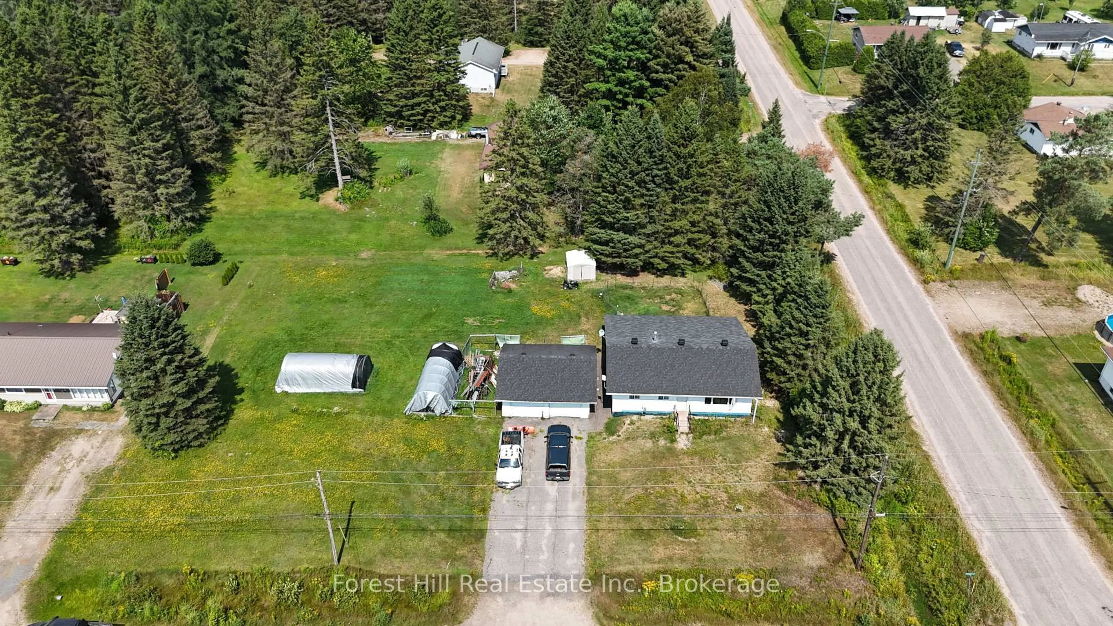 A pic from outside/outdoor area/front of a property/back of a property/a pic from drone, street for 502 Sweezy St, Powassan Ontario P0H 2L0