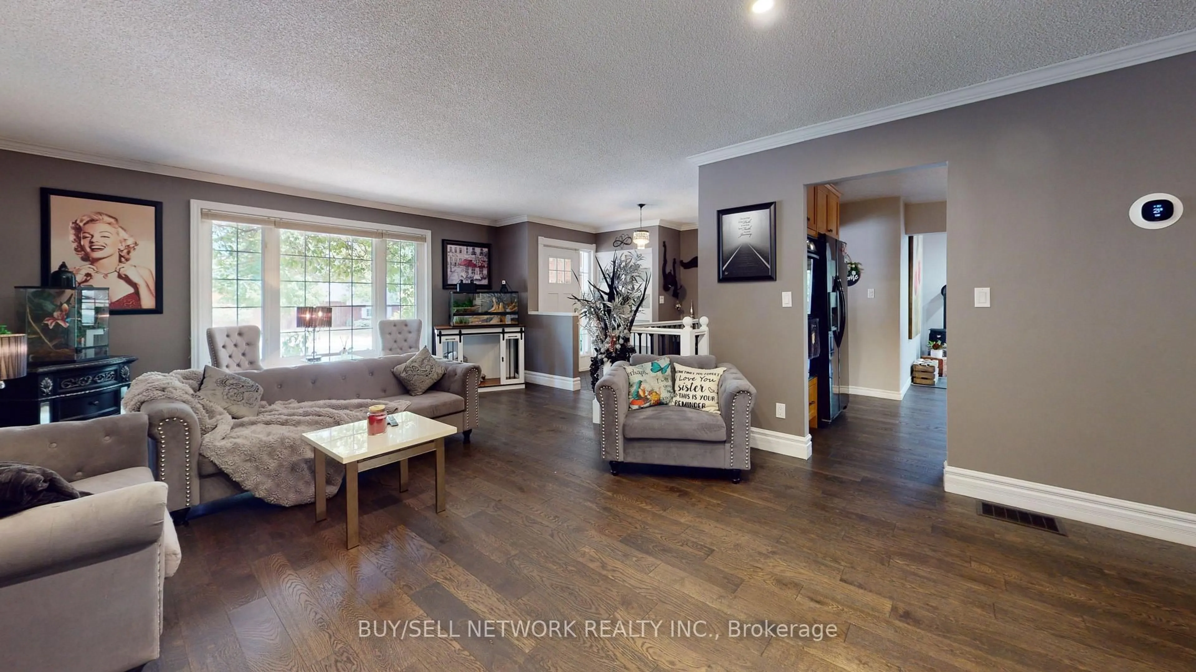 Living room with furniture, wood/laminate floor for 2504 Idyllwood Cres, Peterborough East Ontario K9L 1Y9