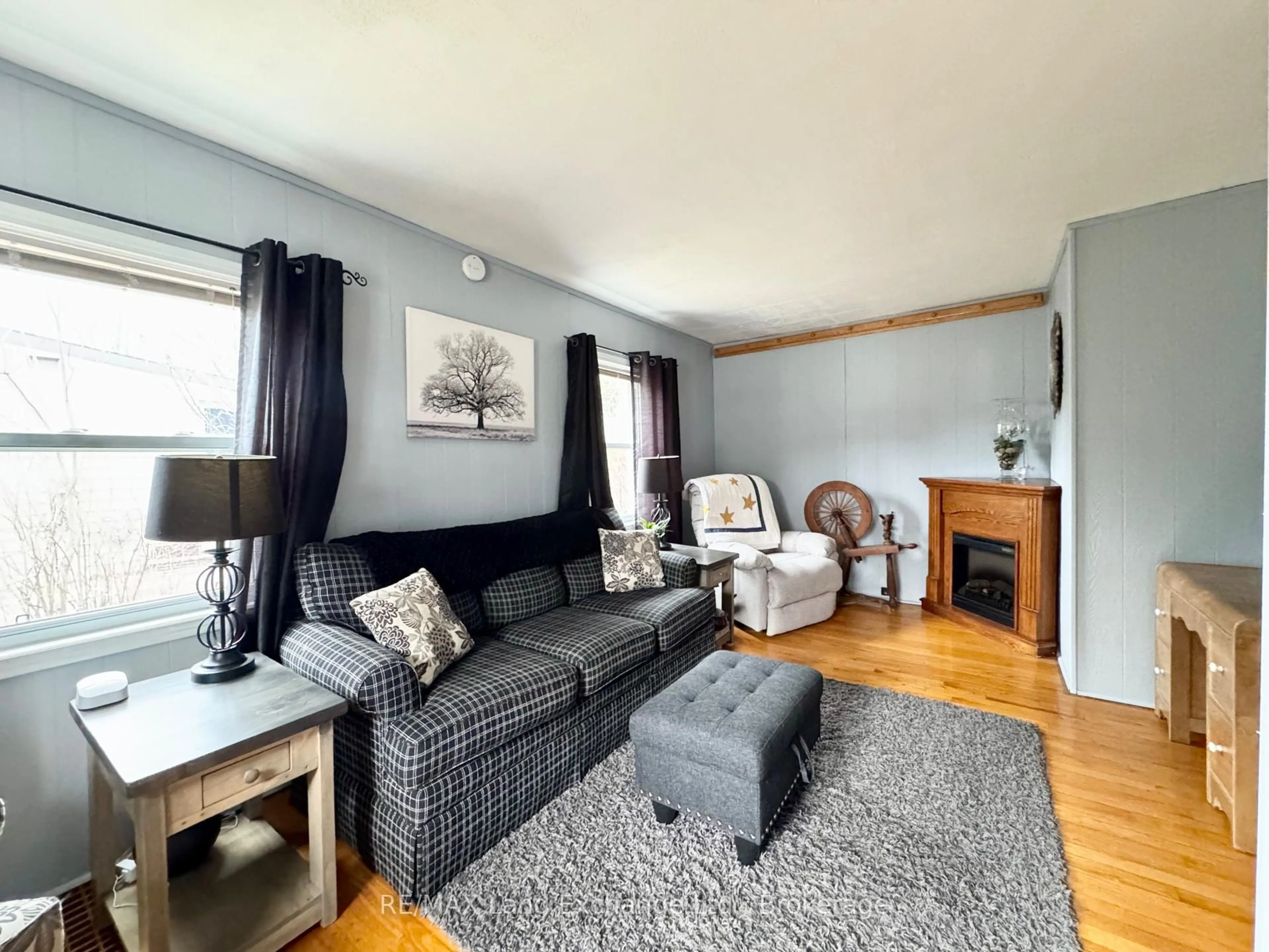 Living room with furniture, wood/laminate floor for 677 Louis St, Saugeen Shores Ontario N0H 2C4