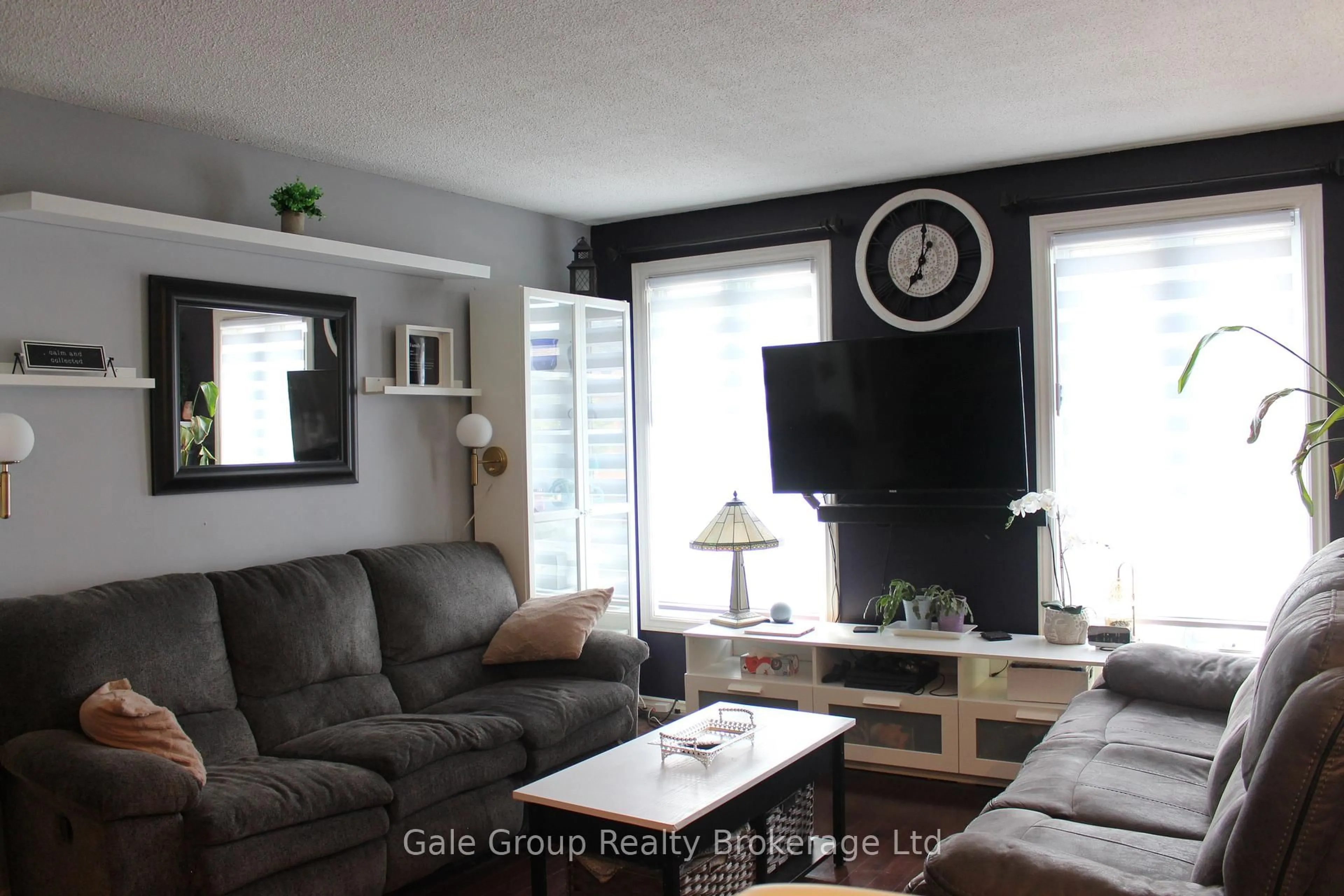 Living room with furniture, wood/laminate floor for 1133 Pearson Dr, Woodstock Ontario N4S 8J4
