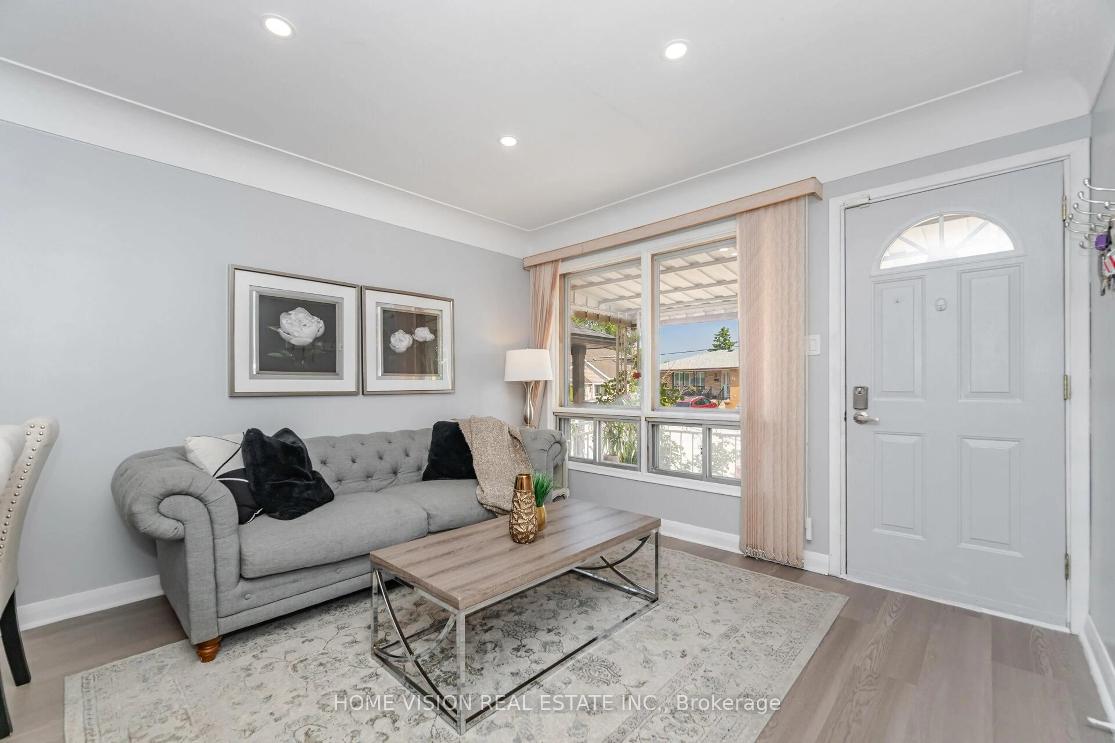 Living room with furniture, wood/laminate floor for 15 Adair Ave, Hamilton Ontario L8H 6A5