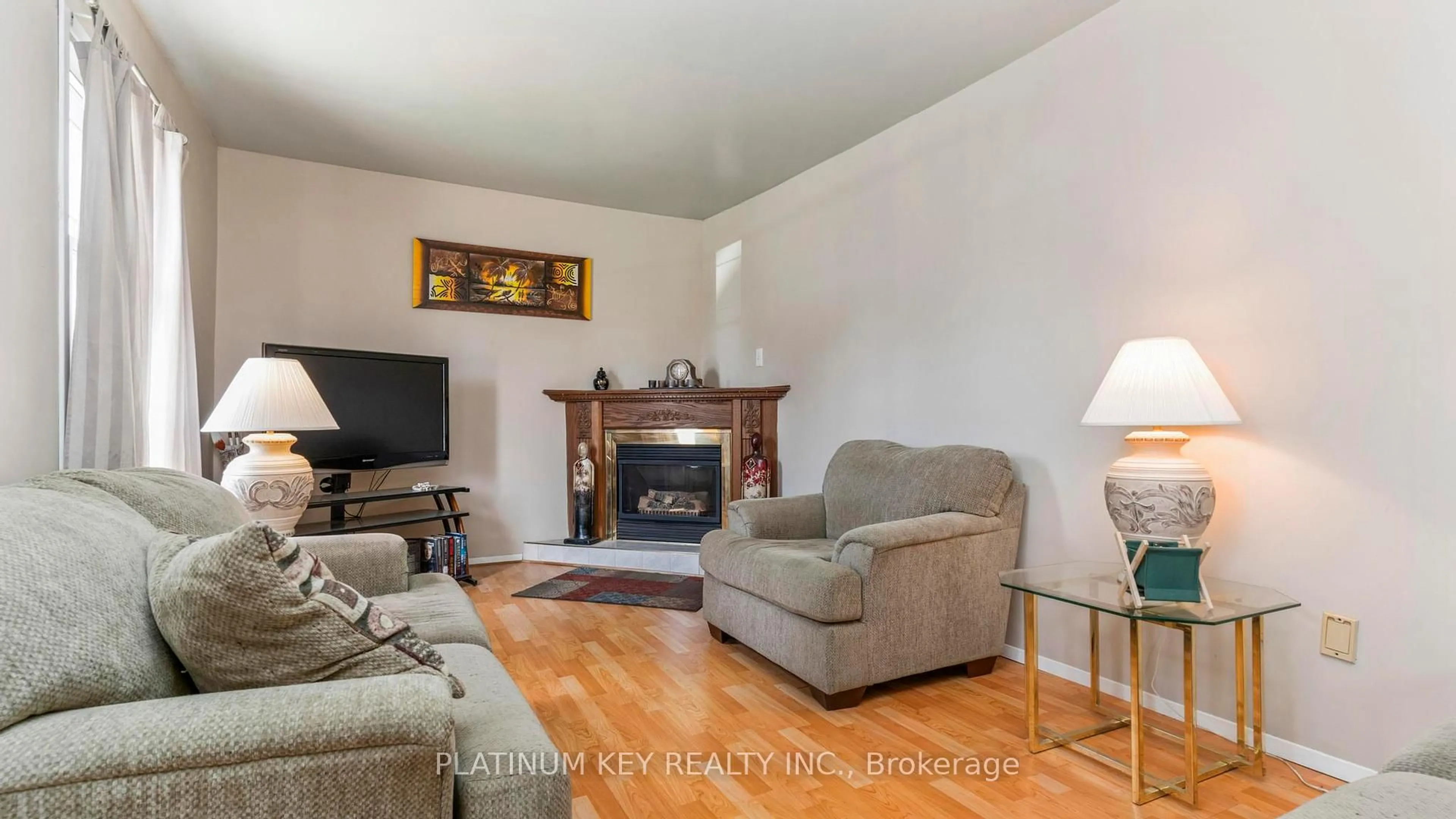 Living room with furniture, wood/laminate floor for 41 Queen St, Strathroy-Caradoc Ontario N7G 2H5