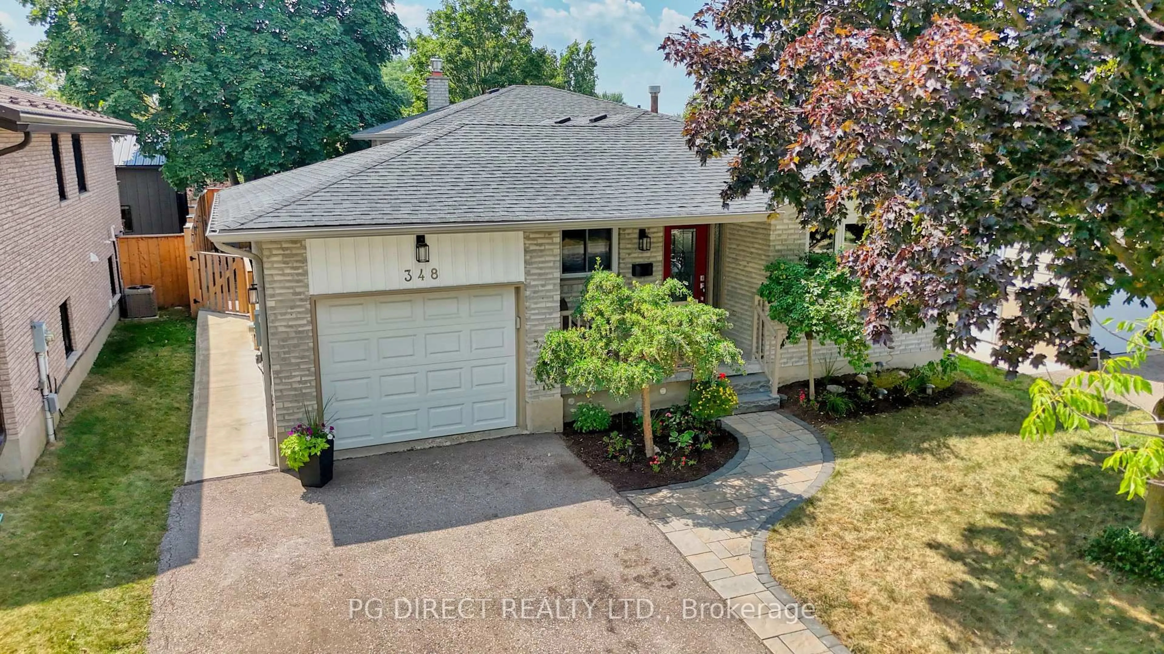 Home with brick exterior material, street for 348 Wintergreen Dr, Waterloo Ontario N2V 1L9