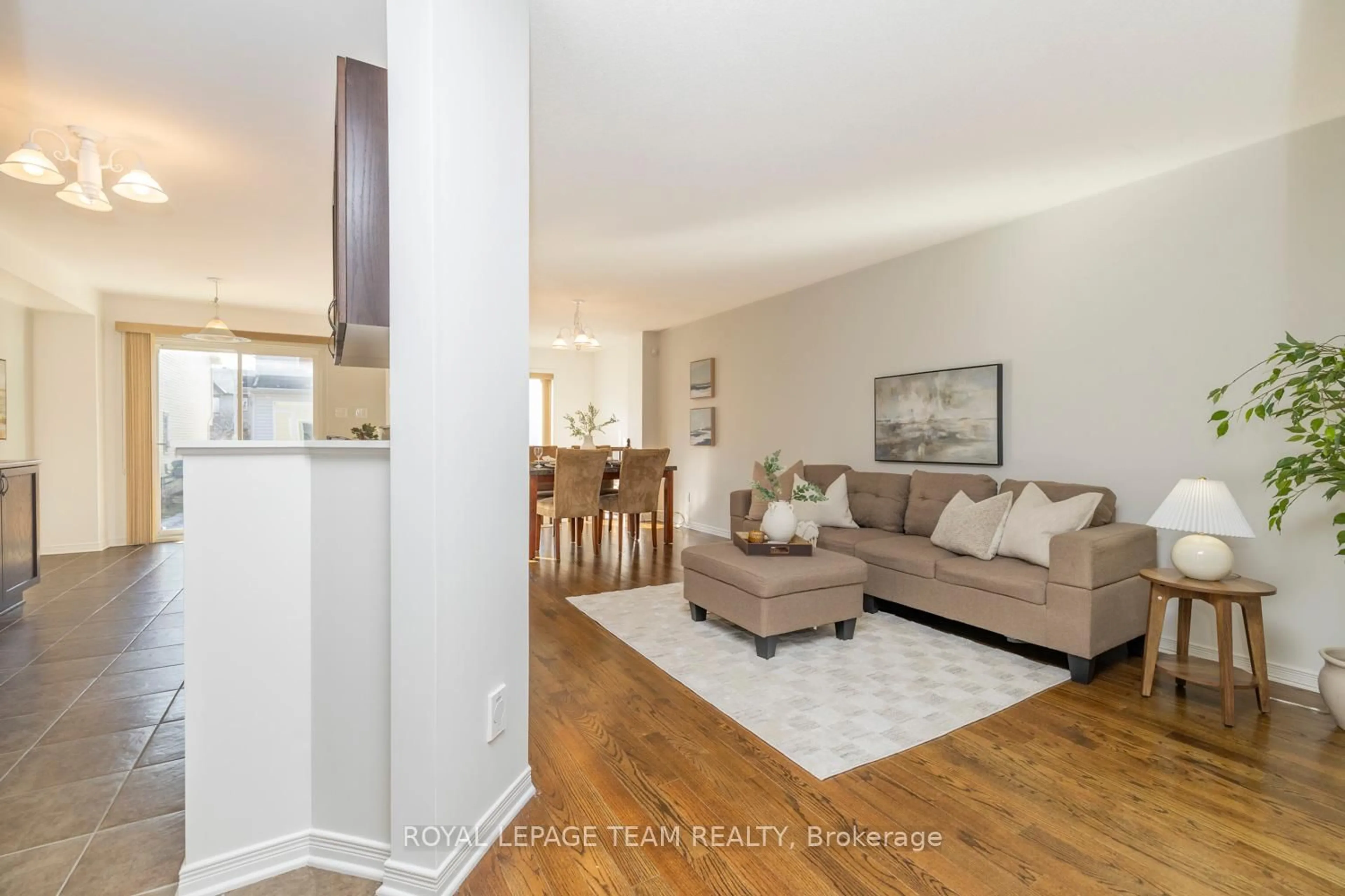 Living room with furniture, wood/laminate floor for 209 Macoun Circ, Ottawa Ontario K1T 0H9