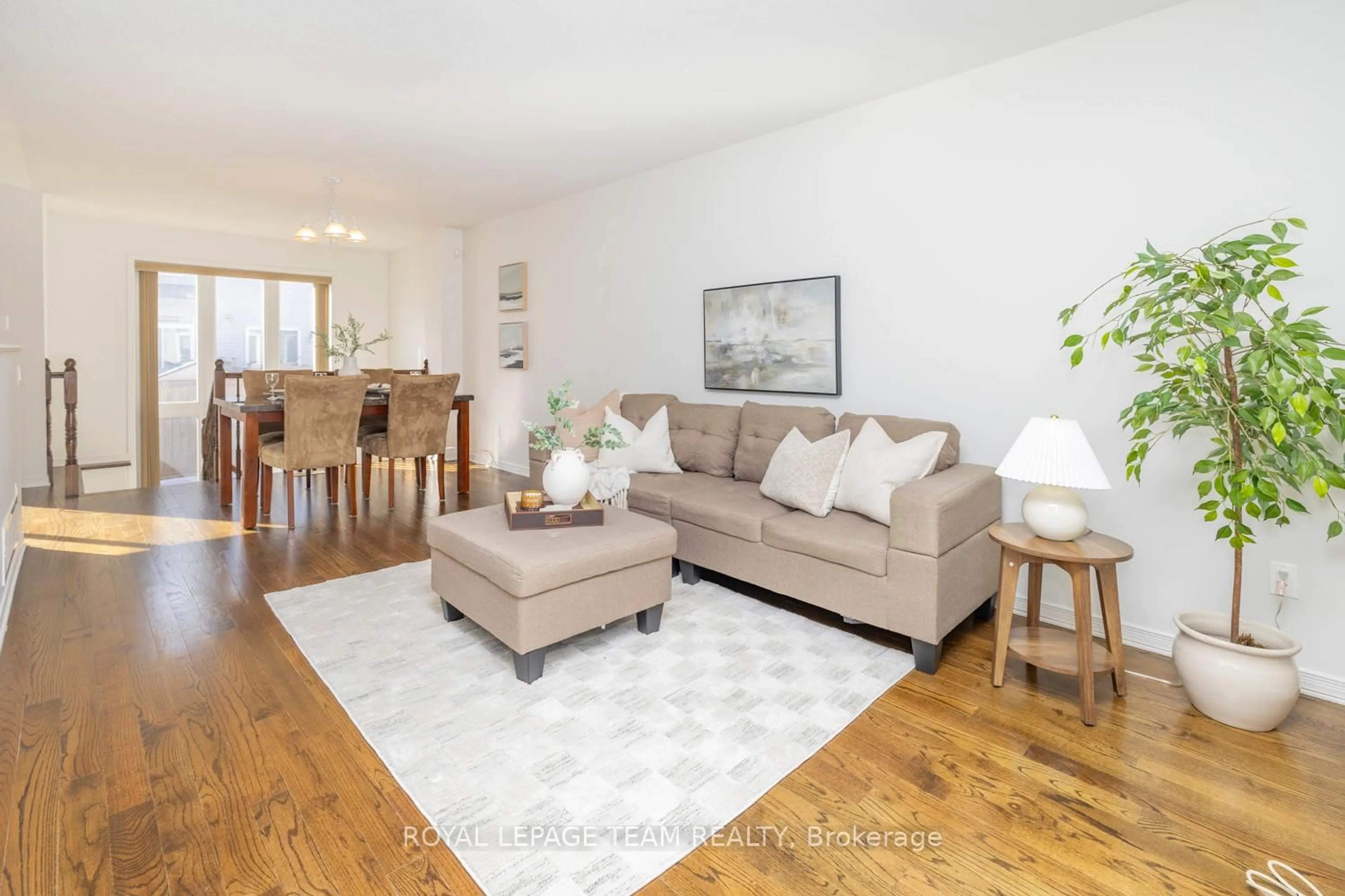 Living room with furniture, wood/laminate floor for 209 Macoun Circ, Ottawa Ontario K1T 0H9