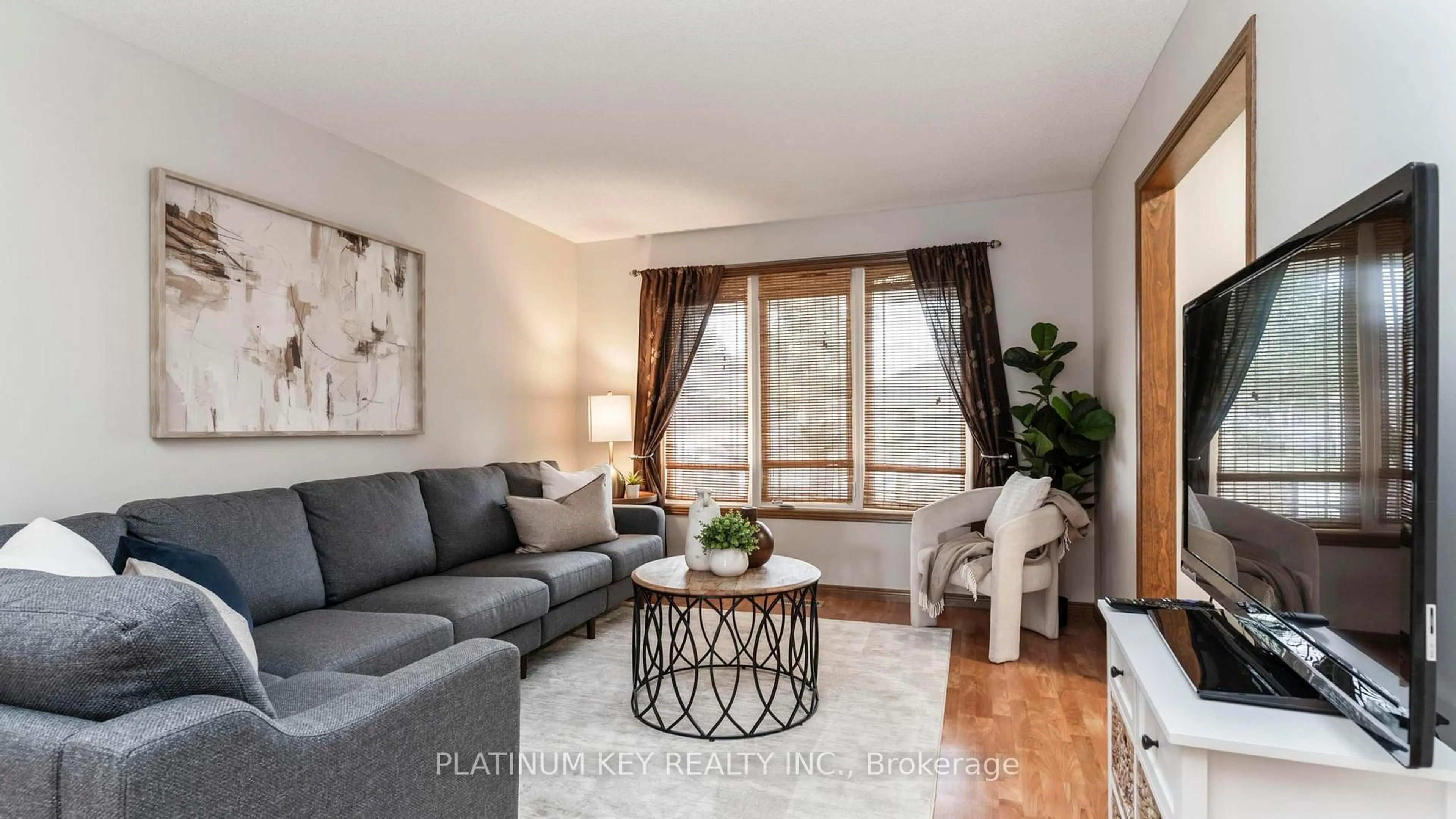 Living room with furniture, wood/laminate floor for 51 Queensway Dr, Strathroy-Caradoc Ontario N7G 4M2