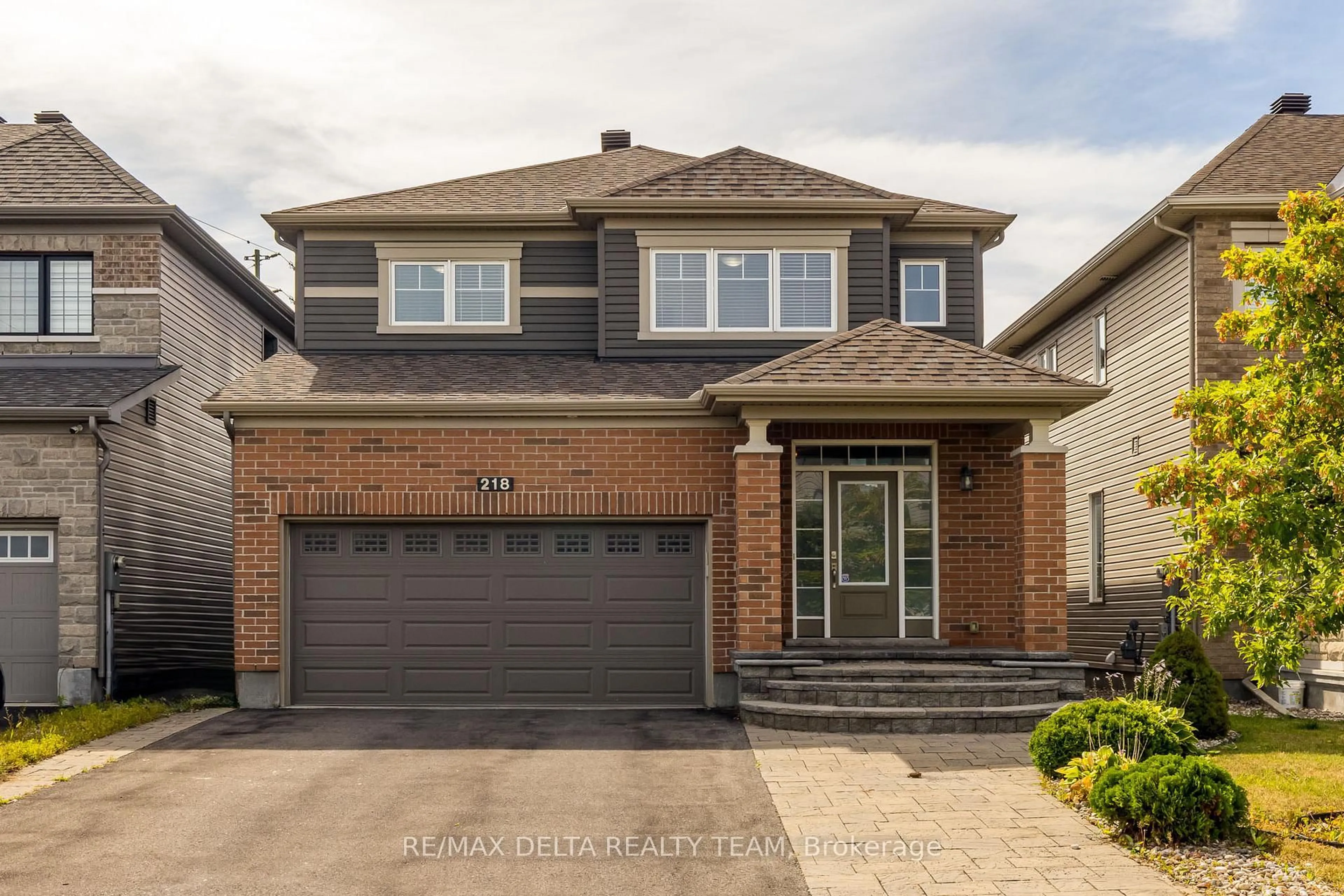 Home with brick exterior material, street for 218 Enclave Walk, Ottawa Ontario K1W 0J4