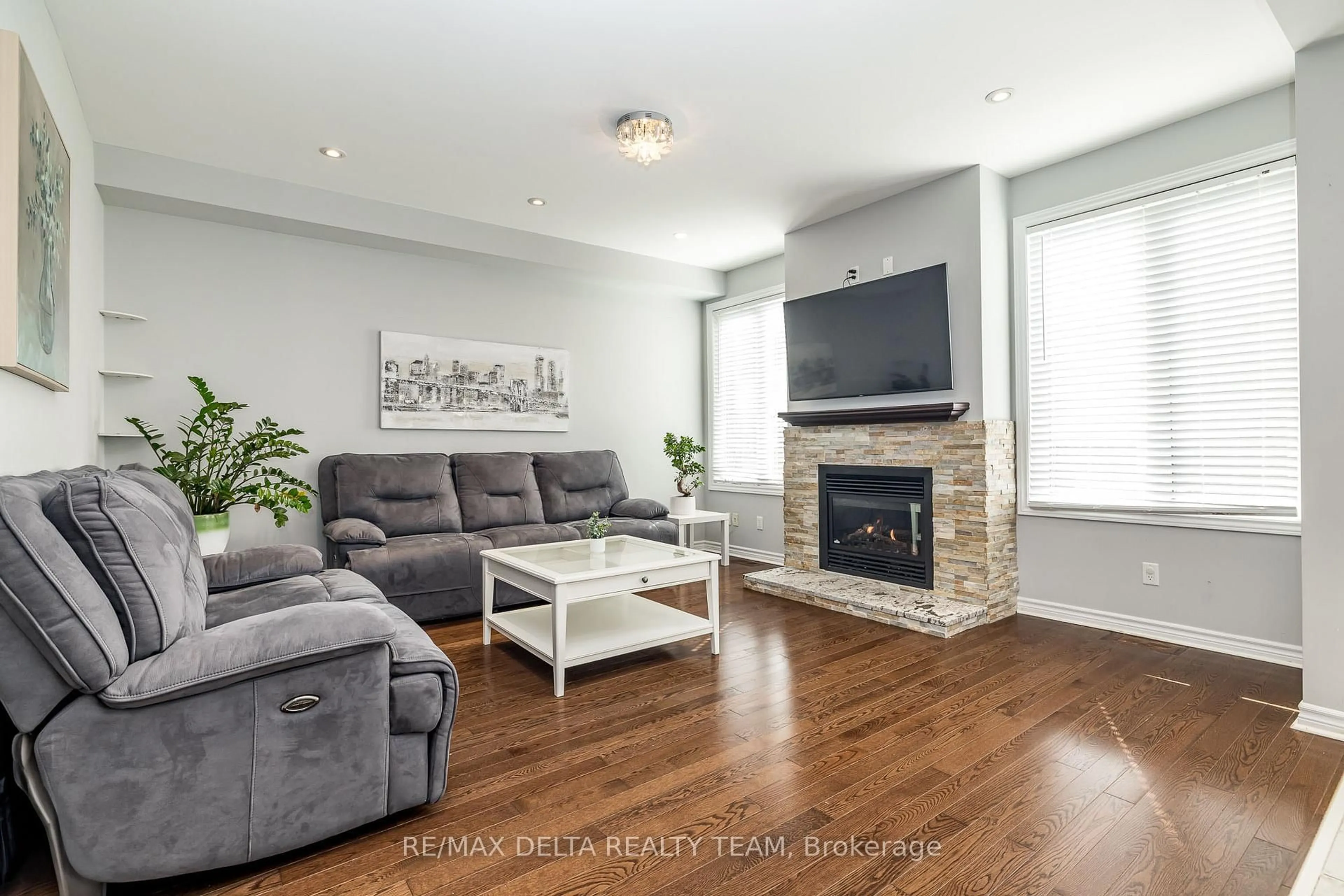 Living room with furniture, wood/laminate floor for 218 Enclave Walk, Ottawa Ontario K1W 0J4