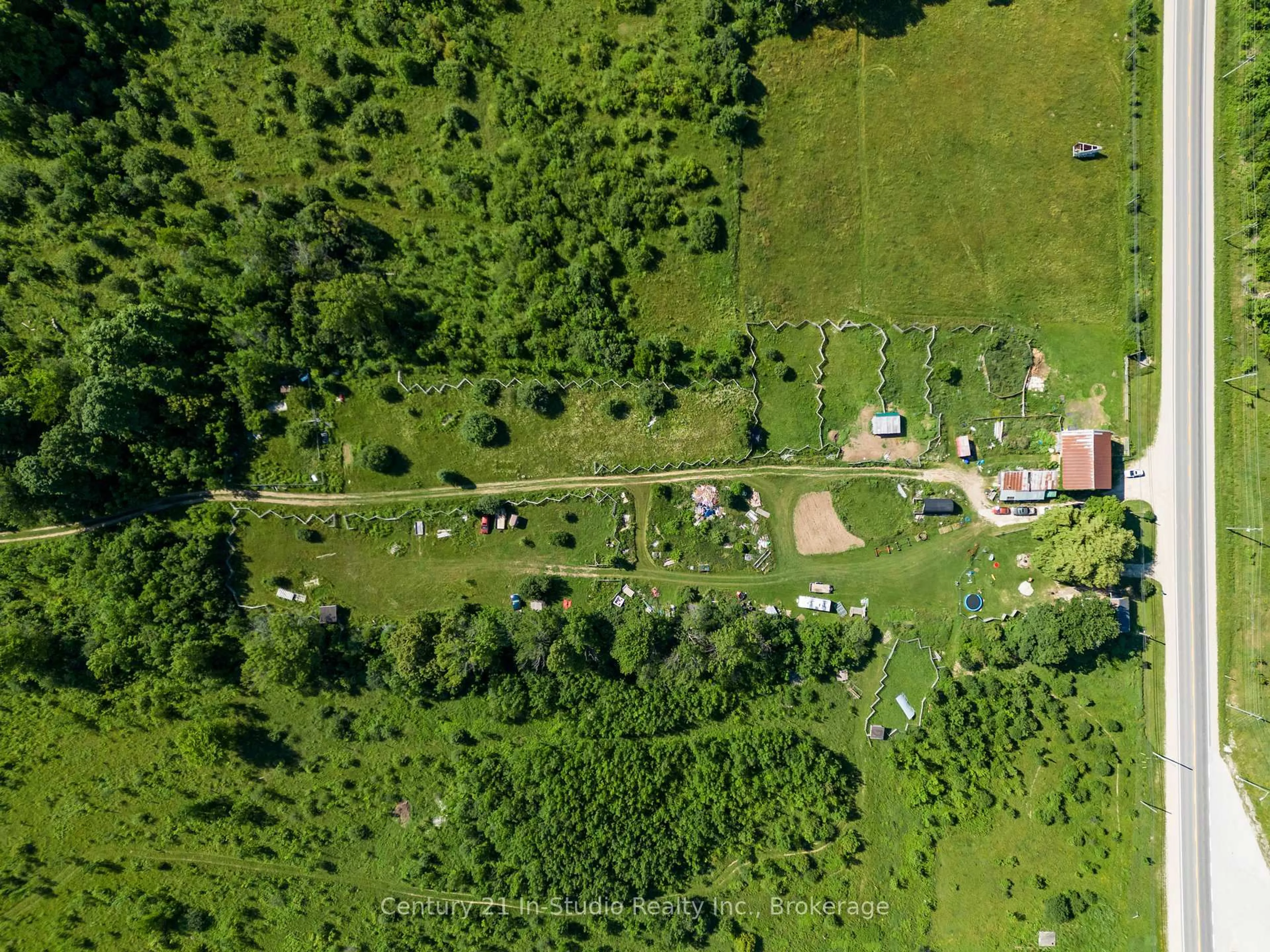 A pic from outside/outdoor area/front of a property/back of a property/a pic from drone, forest/trees view for 318143 6 & 10 Highway, Meaford Ontario N4K 6K9