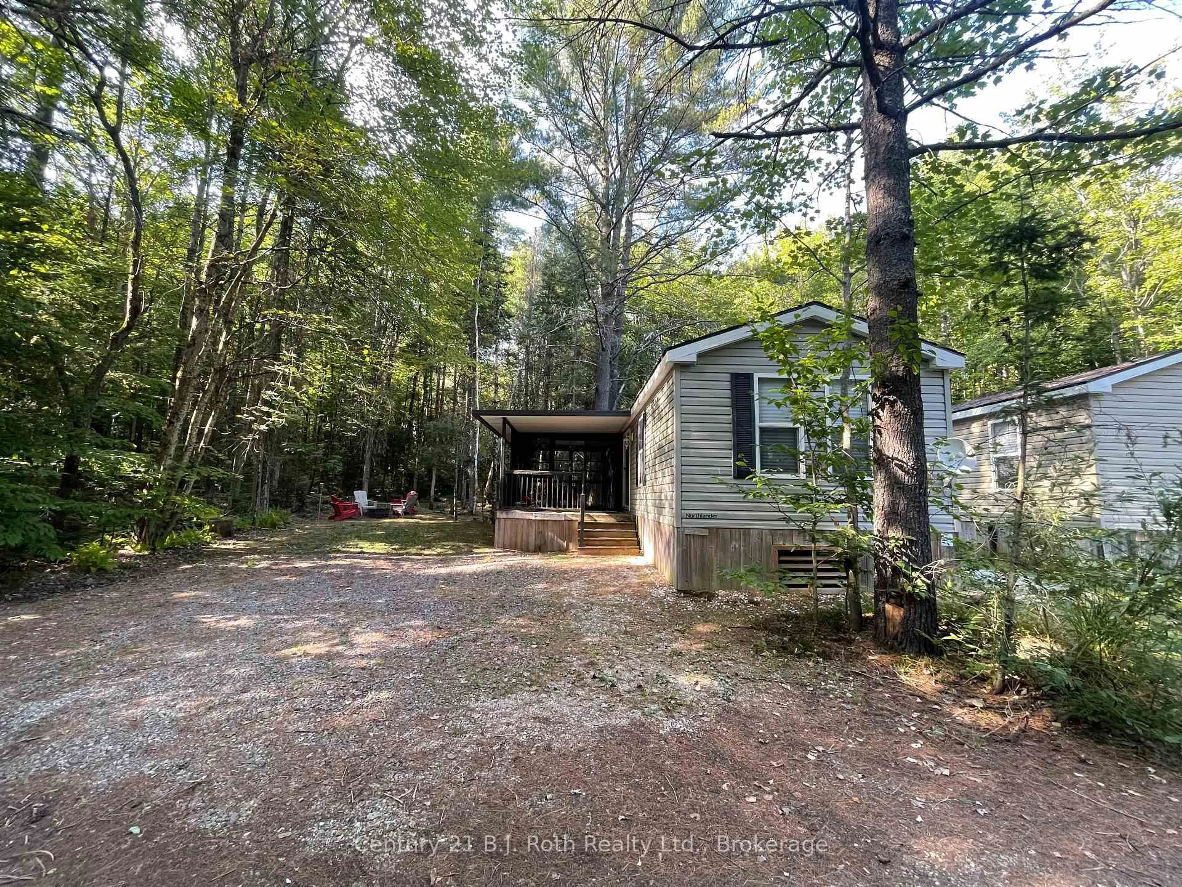 A pic from outside/outdoor area/front of a property/back of a property/a pic from drone, forest/trees view for 1047 Bonnie Lake Camp Rd #804, Bracebridge Ontario P1L 1L9