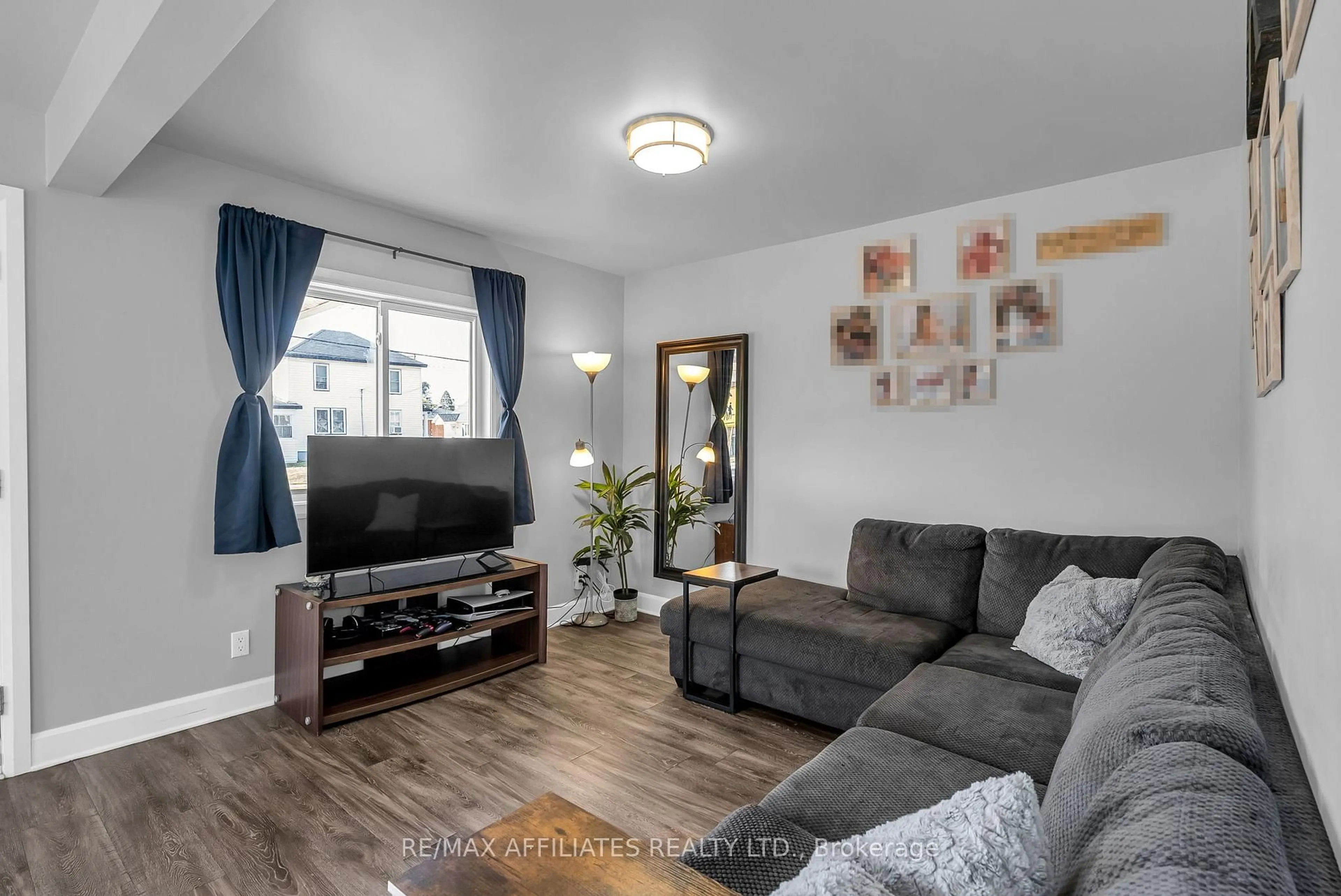 Living room with furniture, wood/laminate floor for 229 Fourth St, Cornwall Ontario K6J 2R9