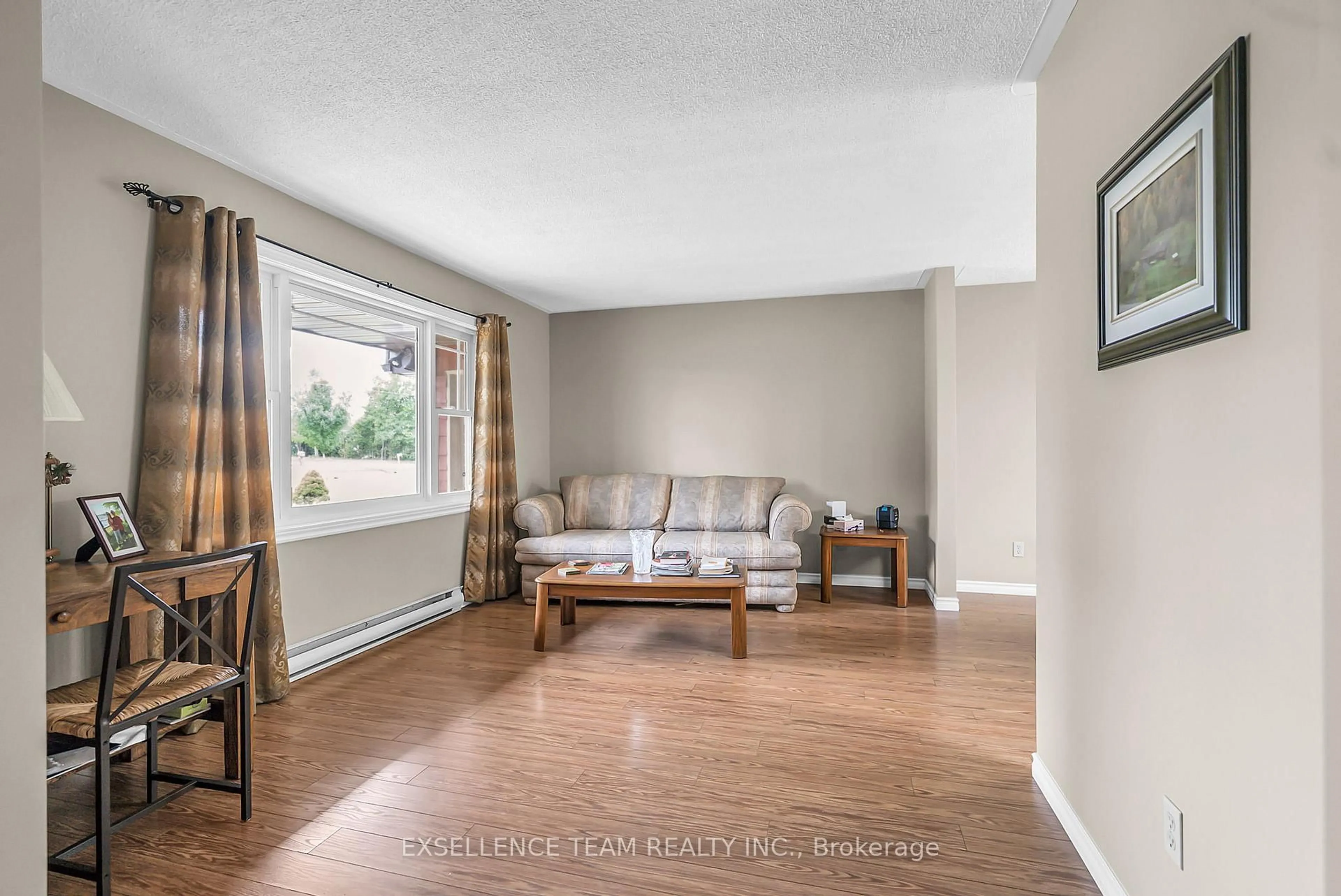 Living room with furniture, wood/laminate floor for 18537 Glen Rd, South Glengarry Ontario K0C 2J0