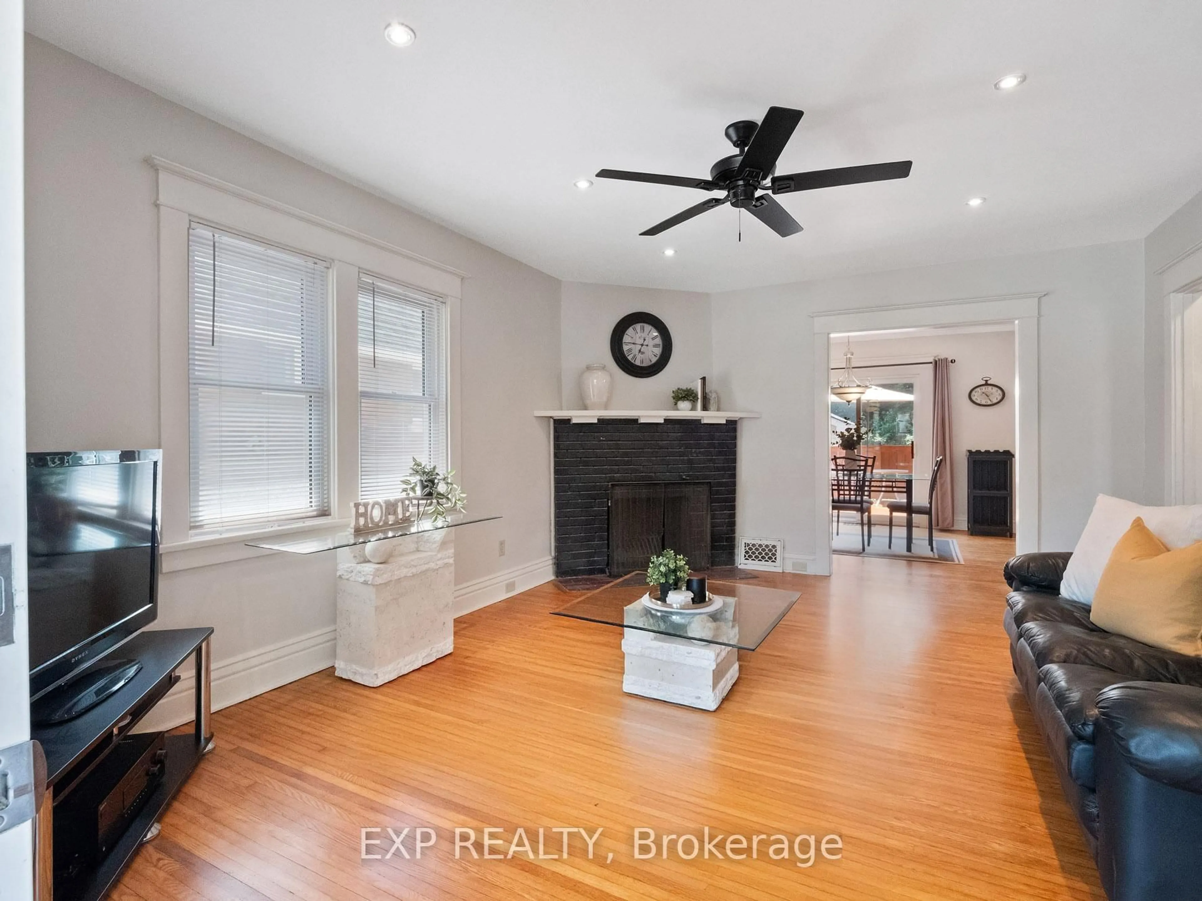 Living room with furniture, wood/laminate floor for 5791 Dorchester Rd, Niagara Falls Ontario L2G 5S6