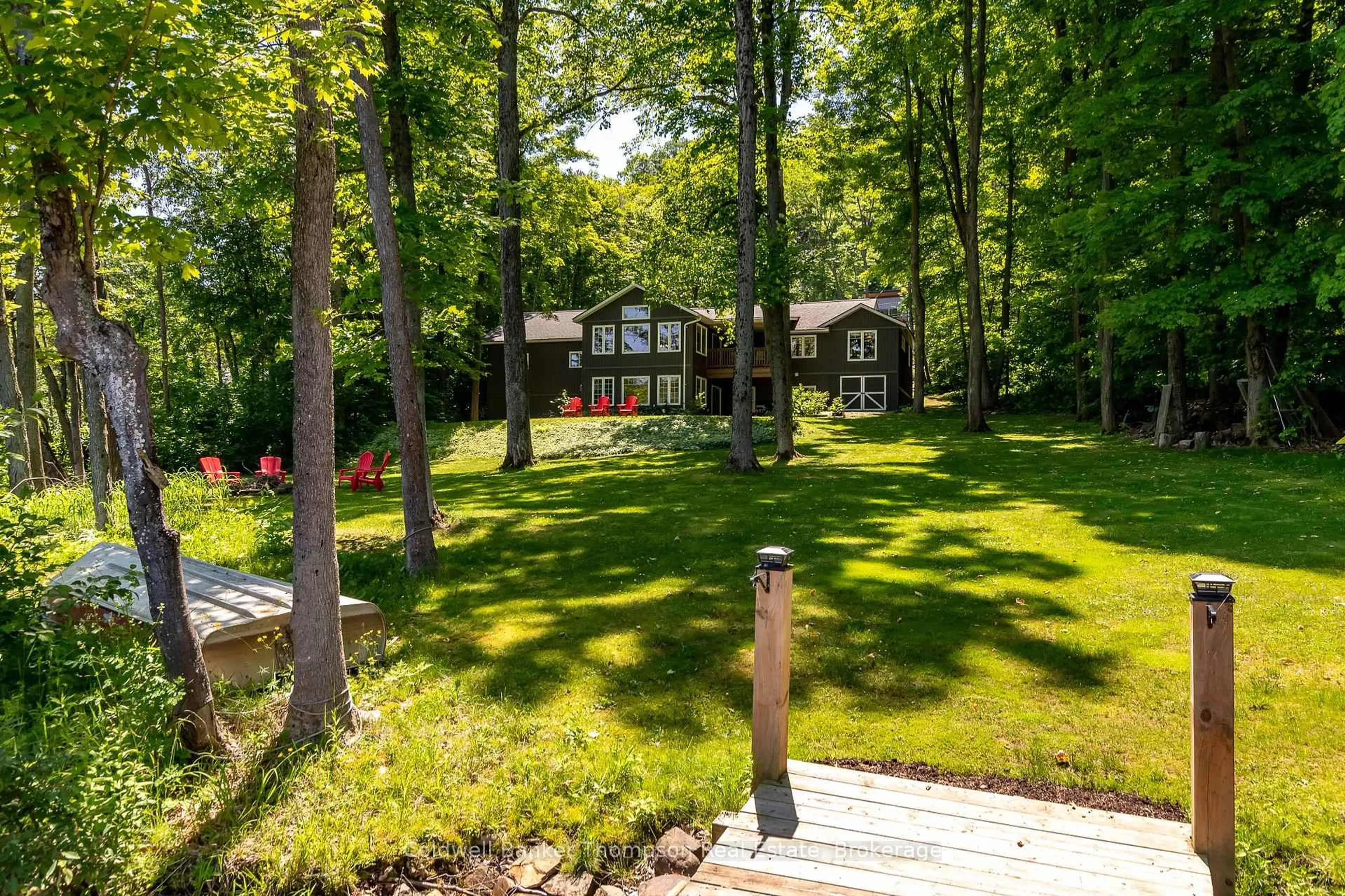 A pic from outside/outdoor area/front of a property/back of a property/a pic from drone, forest/trees view for 440 Bayshore Blvd, Huntsville Ontario P1H 1Z1