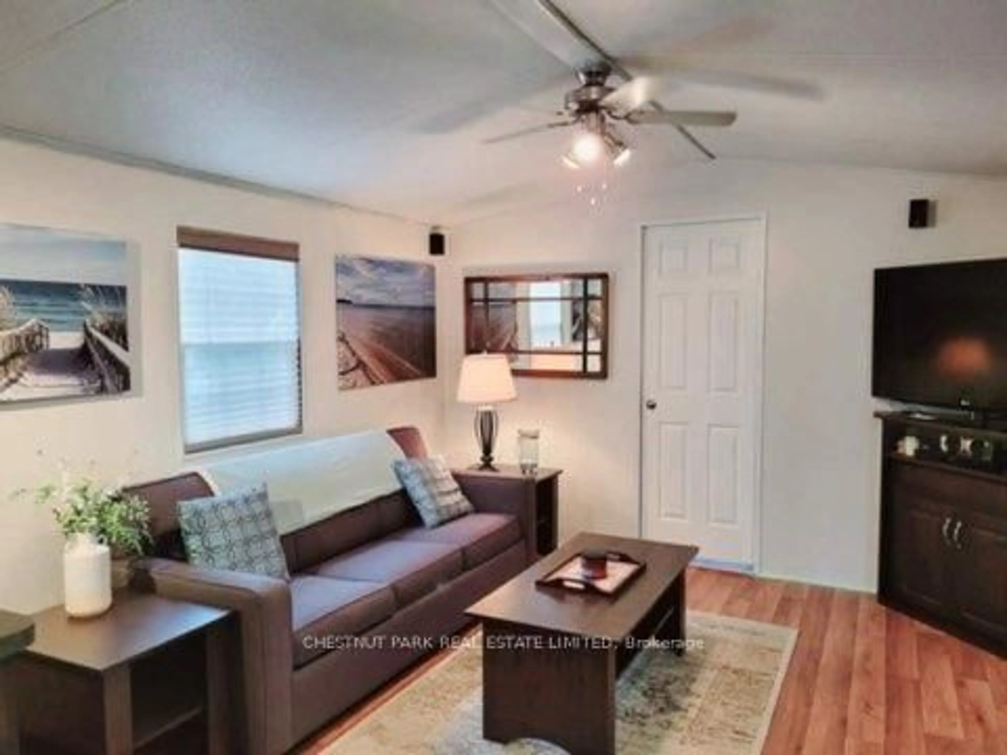 Living room with furniture, wood/laminate floor for 486 County Road 18 #CBL056, Prince Edward County Ontario K0K 1P0