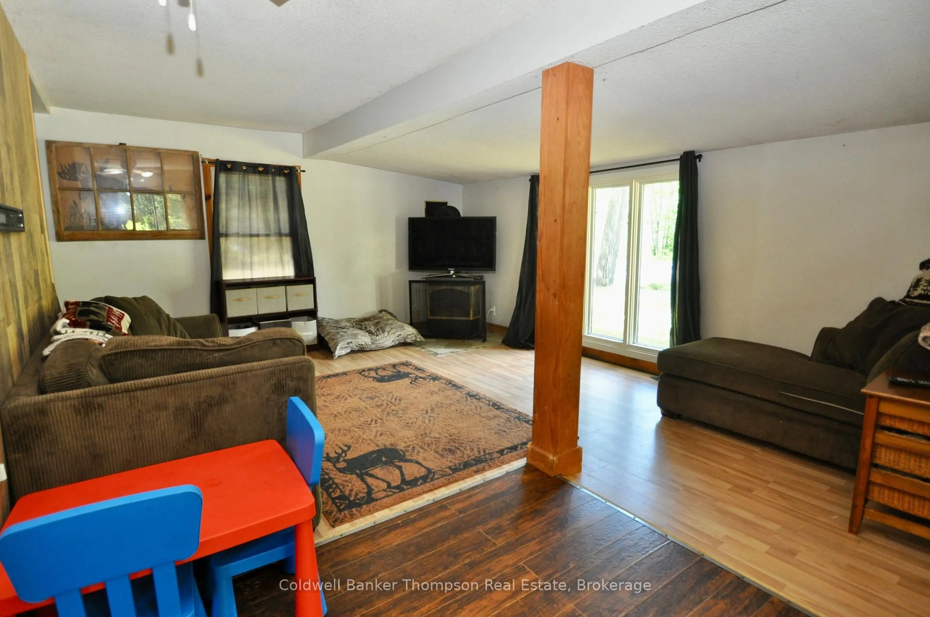 Living room with furniture, wood/laminate floor for 31 Hutcheson Beach Rd, Huntsville Ontario P1H 1N4