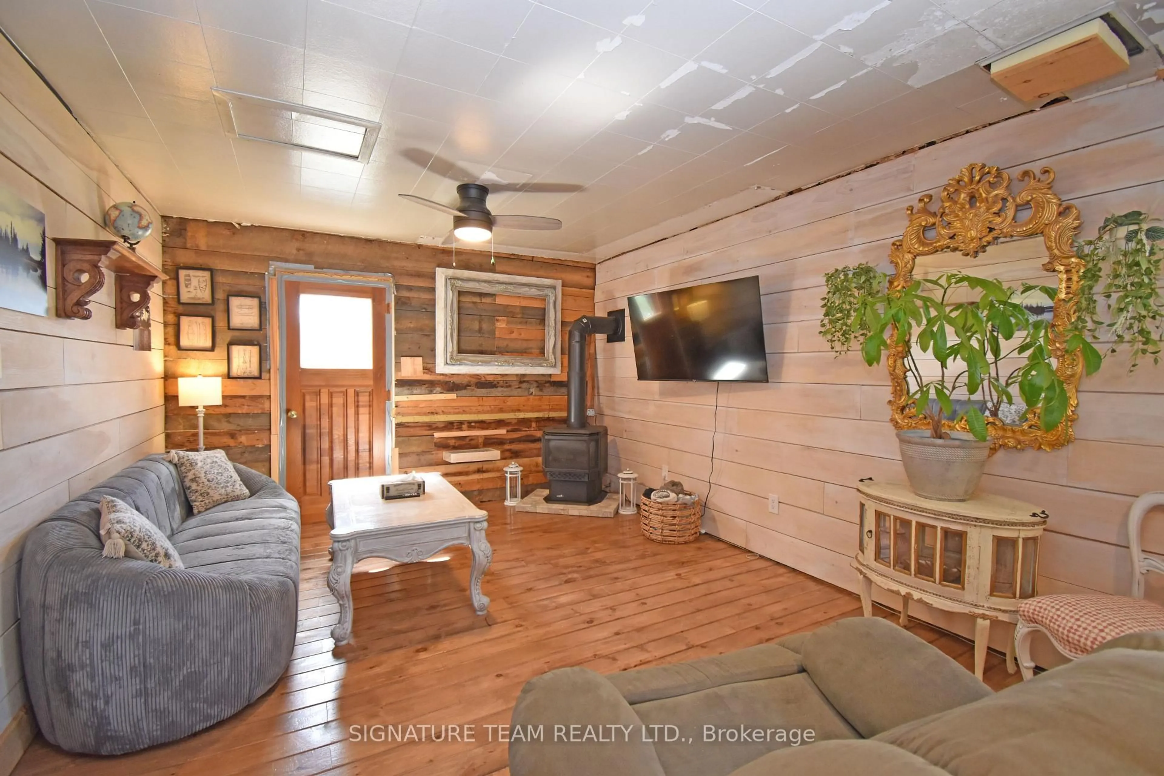 Living room with furniture, wood/laminate floor for 2445 Simpson Pit Rd, Round Lake Centre Ontario K0J 2J0