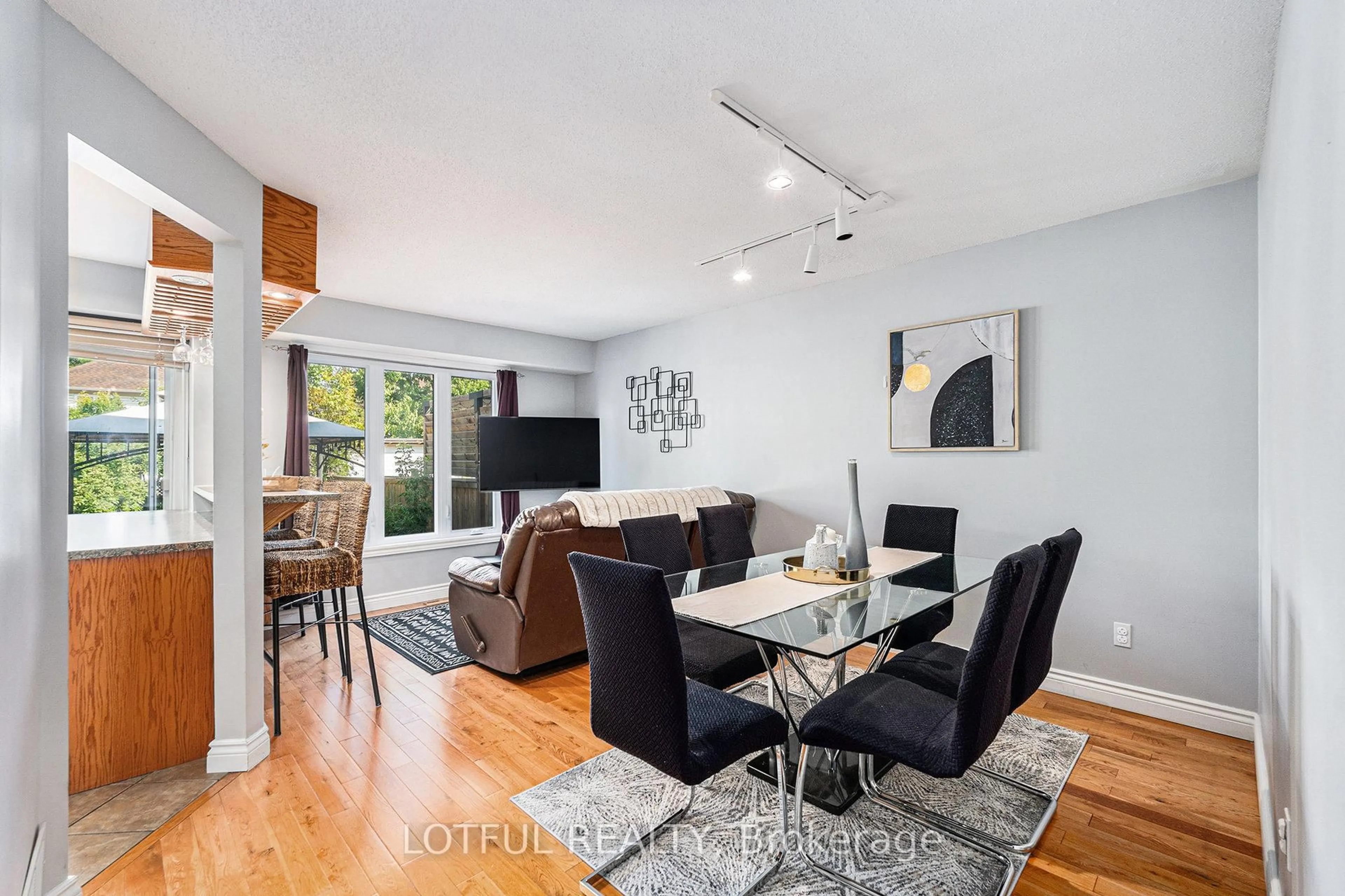 Living room with furniture, wood/laminate floor for 107 Queensbury Dr, Ottawa Ontario K2J 4P2