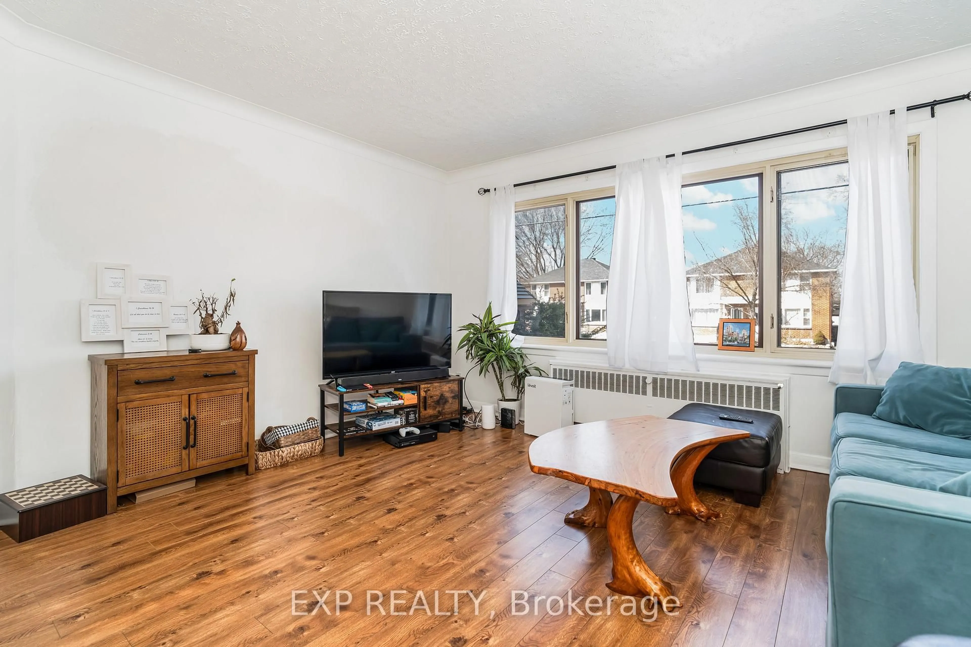 Living room with furniture, wood/laminate floor for 330 Donald St, Ottawa Ontario K1K 1M5
