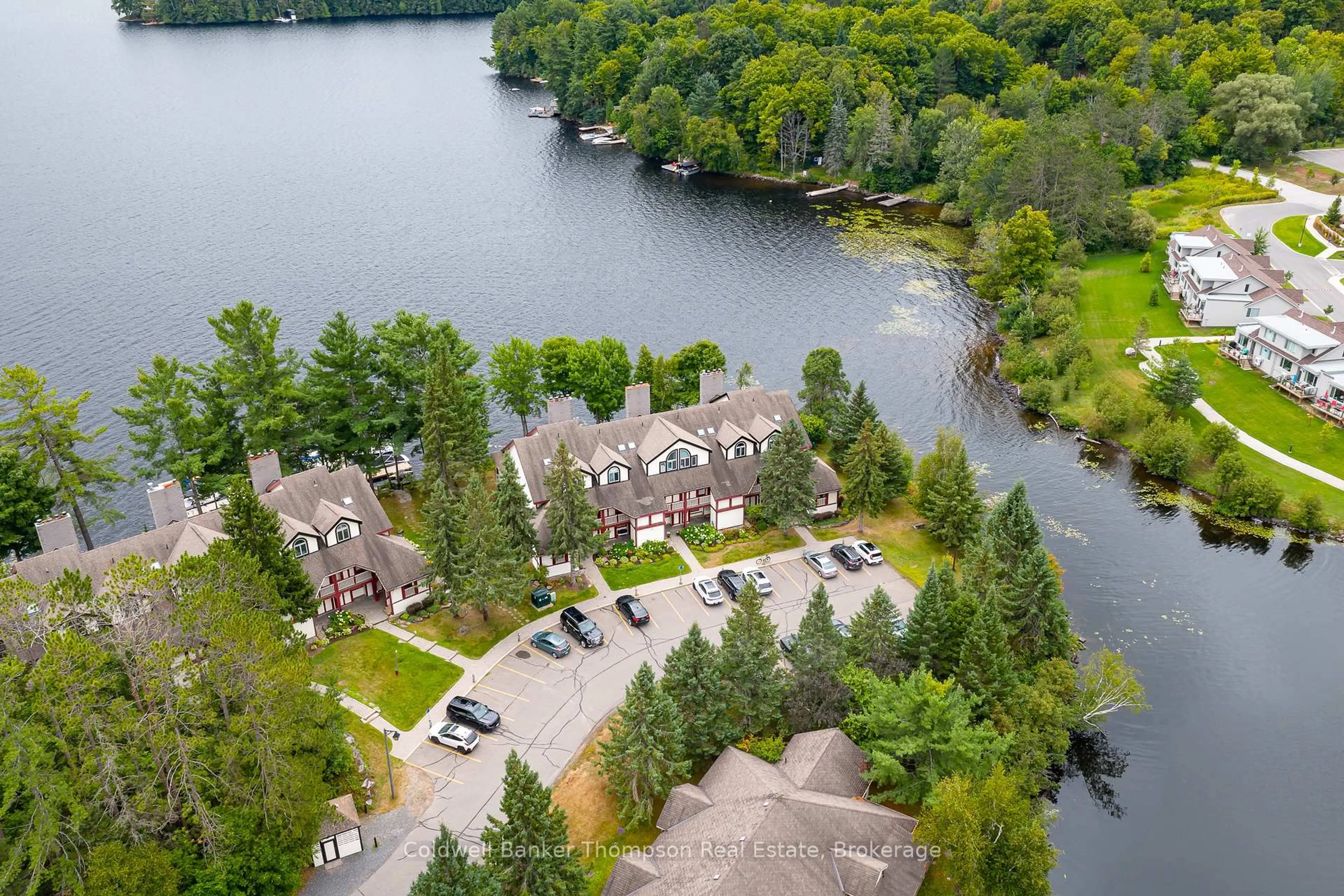 A pic from outside/outdoor area/front of a property/back of a property/a pic from drone, water/lake/river/ocean view for 10 Coveside Dr #204, Huntsville Ontario P1H 1C3