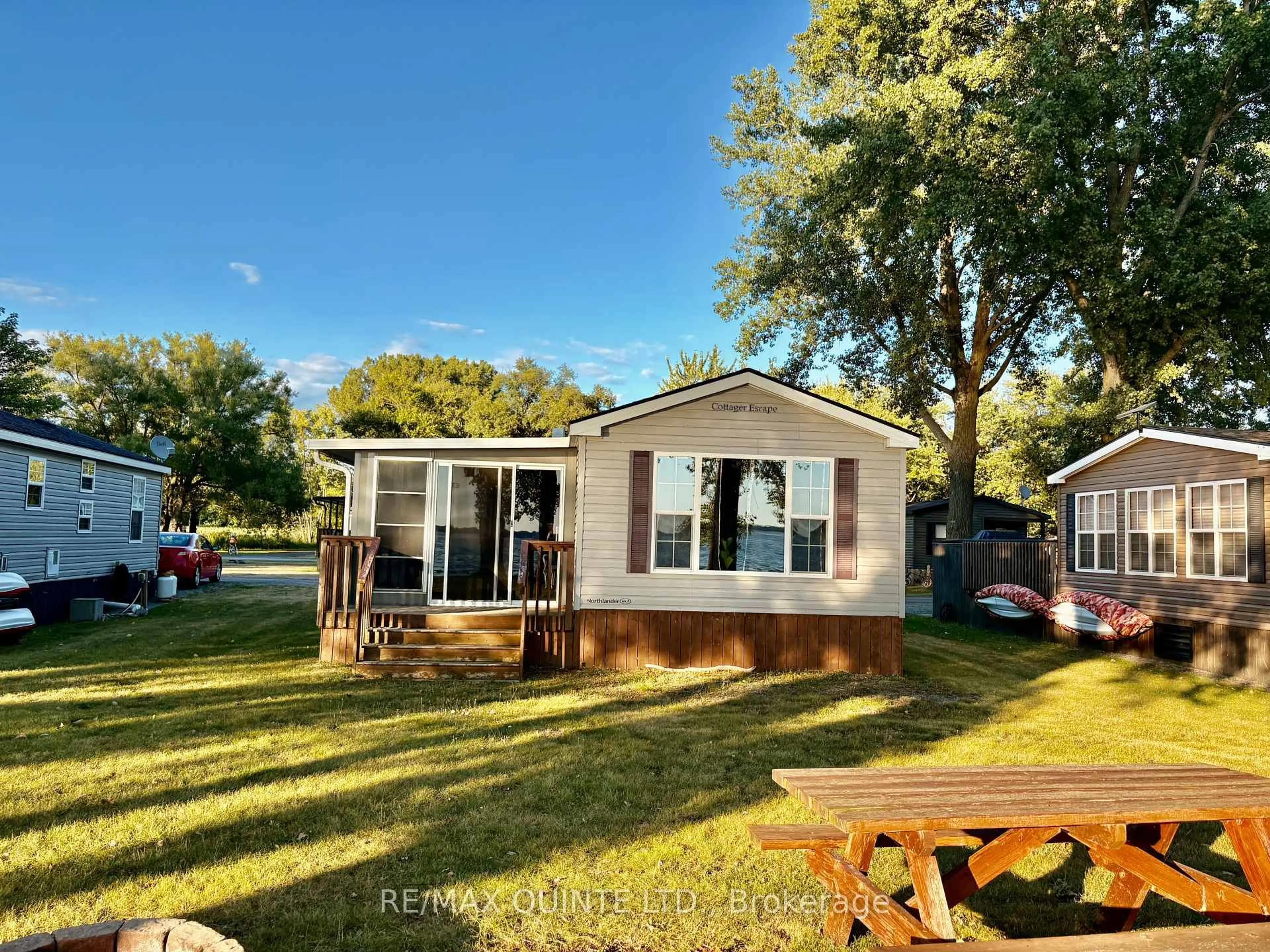 Home with vinyl exterior material, water/lake/river/ocean view for 486 County Rd 18 Rd #23 Beachview Ln, Prince Edward County Ontario K0K 1P0
