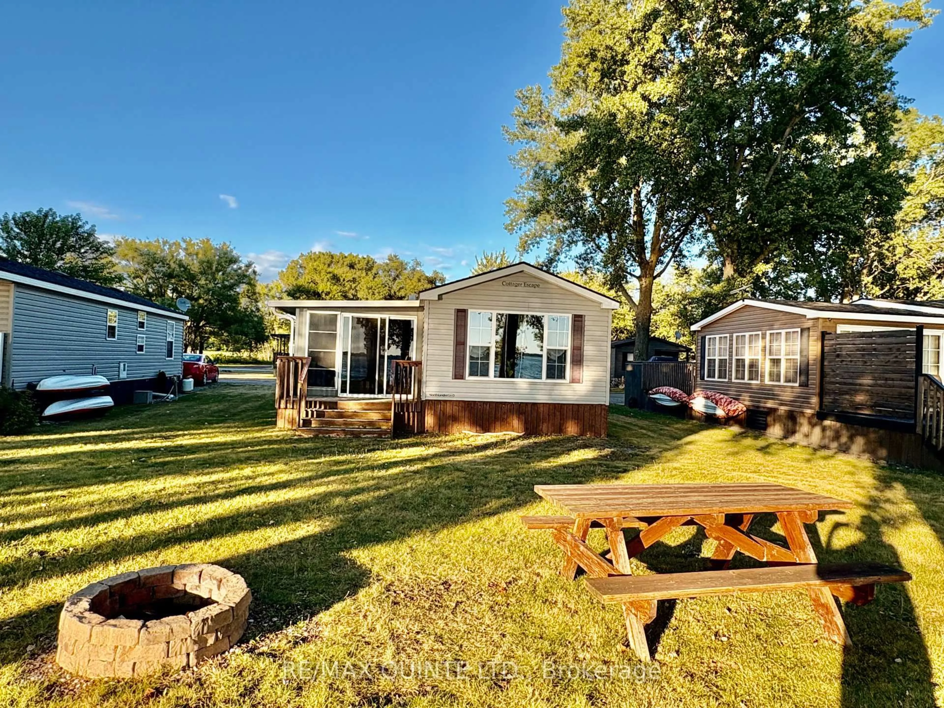 A pic from outside/outdoor area/front of a property/back of a property/a pic from drone, water/lake/river/ocean view for 486 County Rd 18 Rd #23 Beachview Ln, Prince Edward County Ontario K0K 1P0