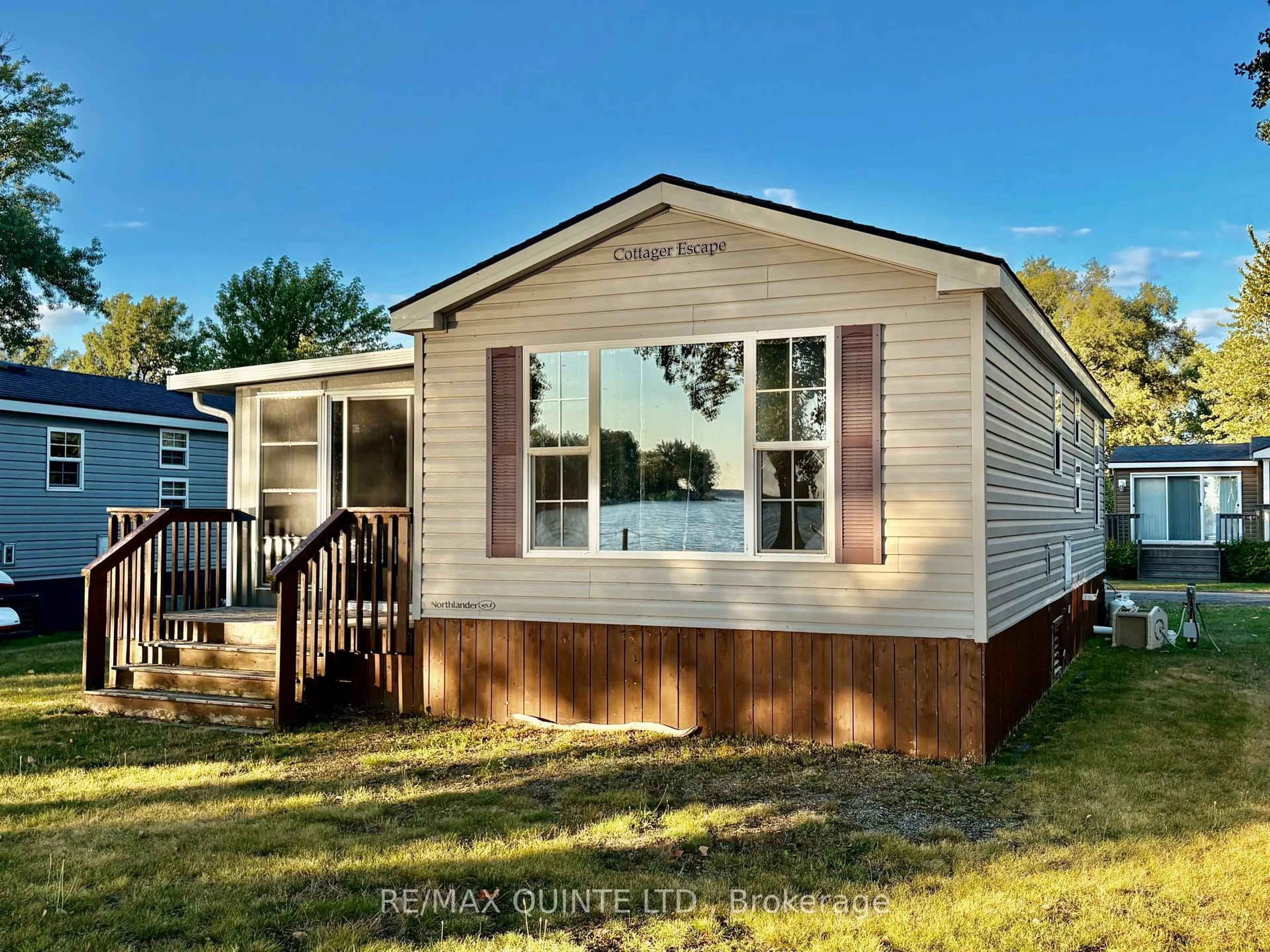 Home with vinyl exterior material, street for 486 County Rd 18 Rd #23 Beachview Ln, Prince Edward County Ontario K0K 1P0
