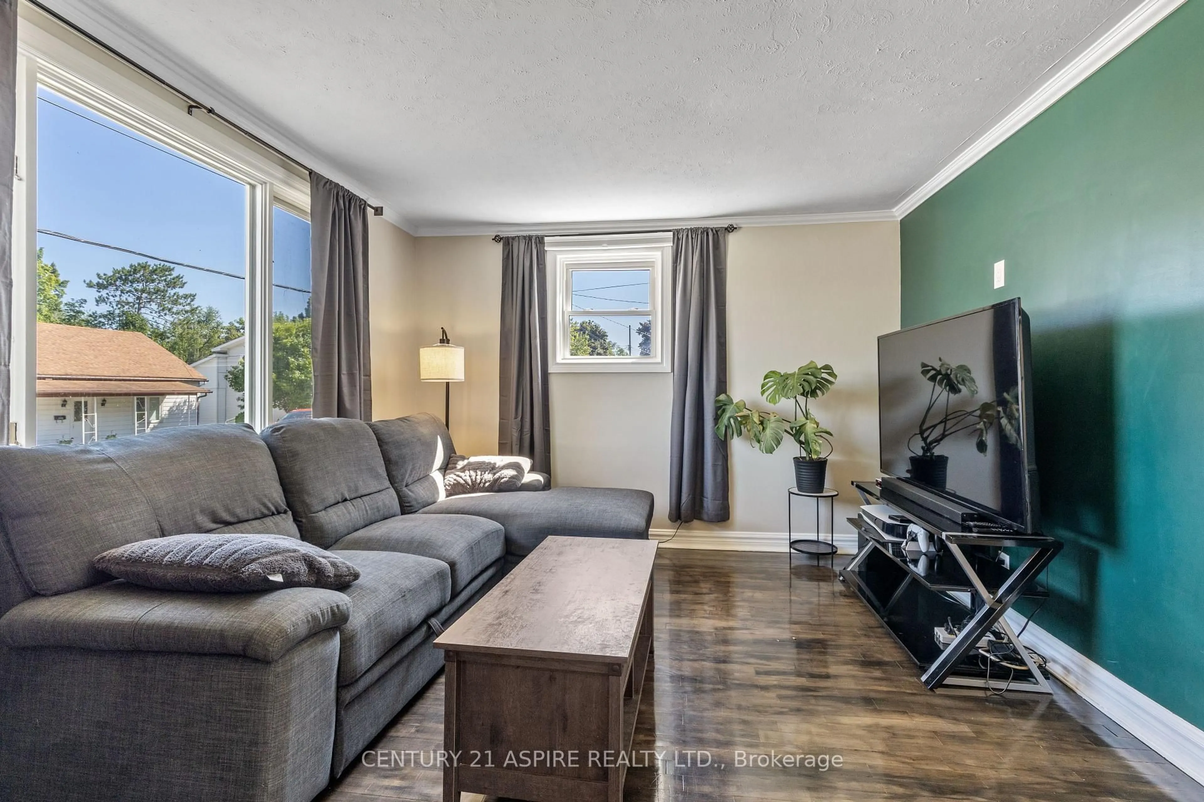 Living room with furniture, wood/laminate floor for 496 Wilbert St, Pembroke Ontario K8A 3G6