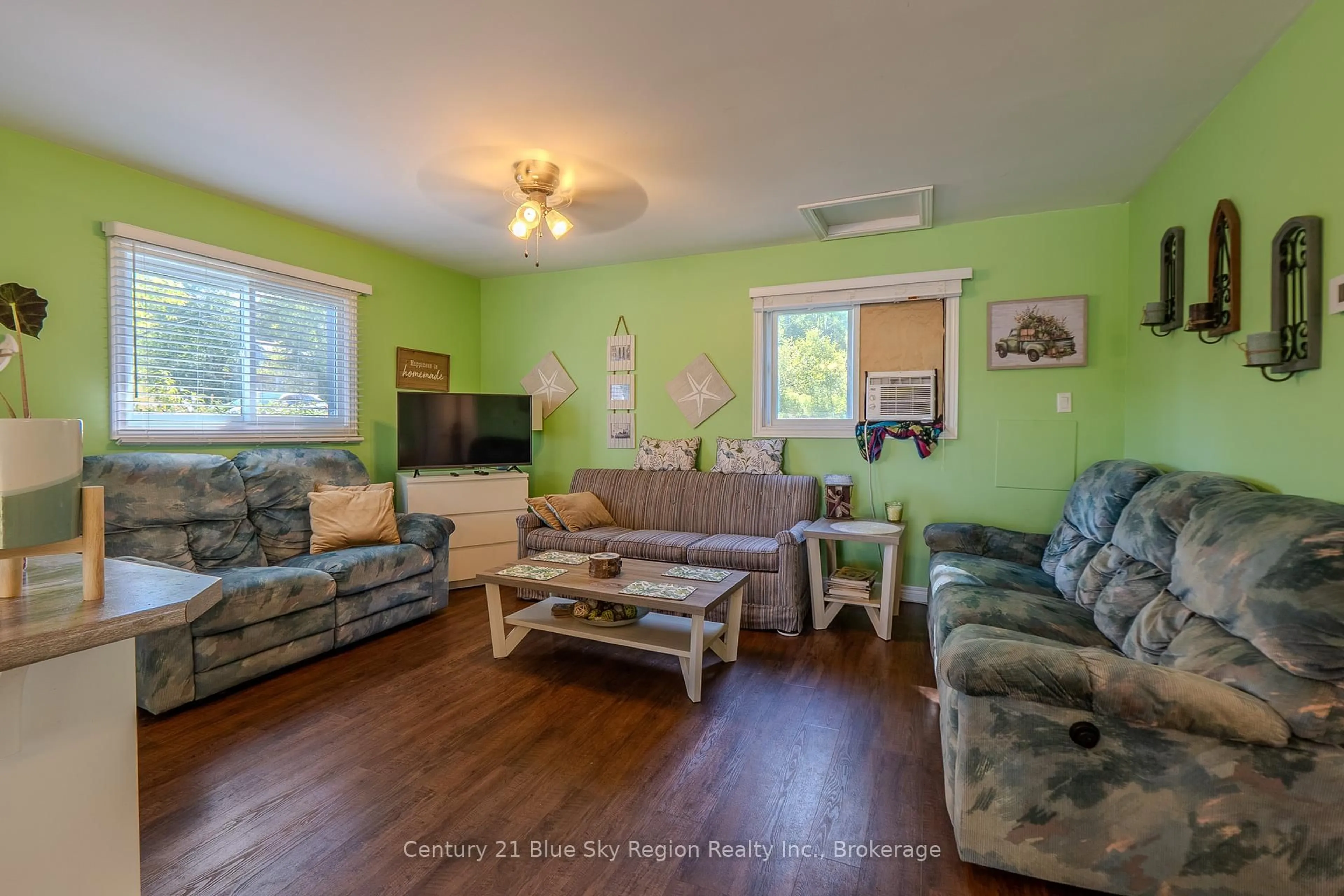Living room with furniture, wood/laminate floor for 58 Marina Rd, East Ferris Ontario P0H 1B0
