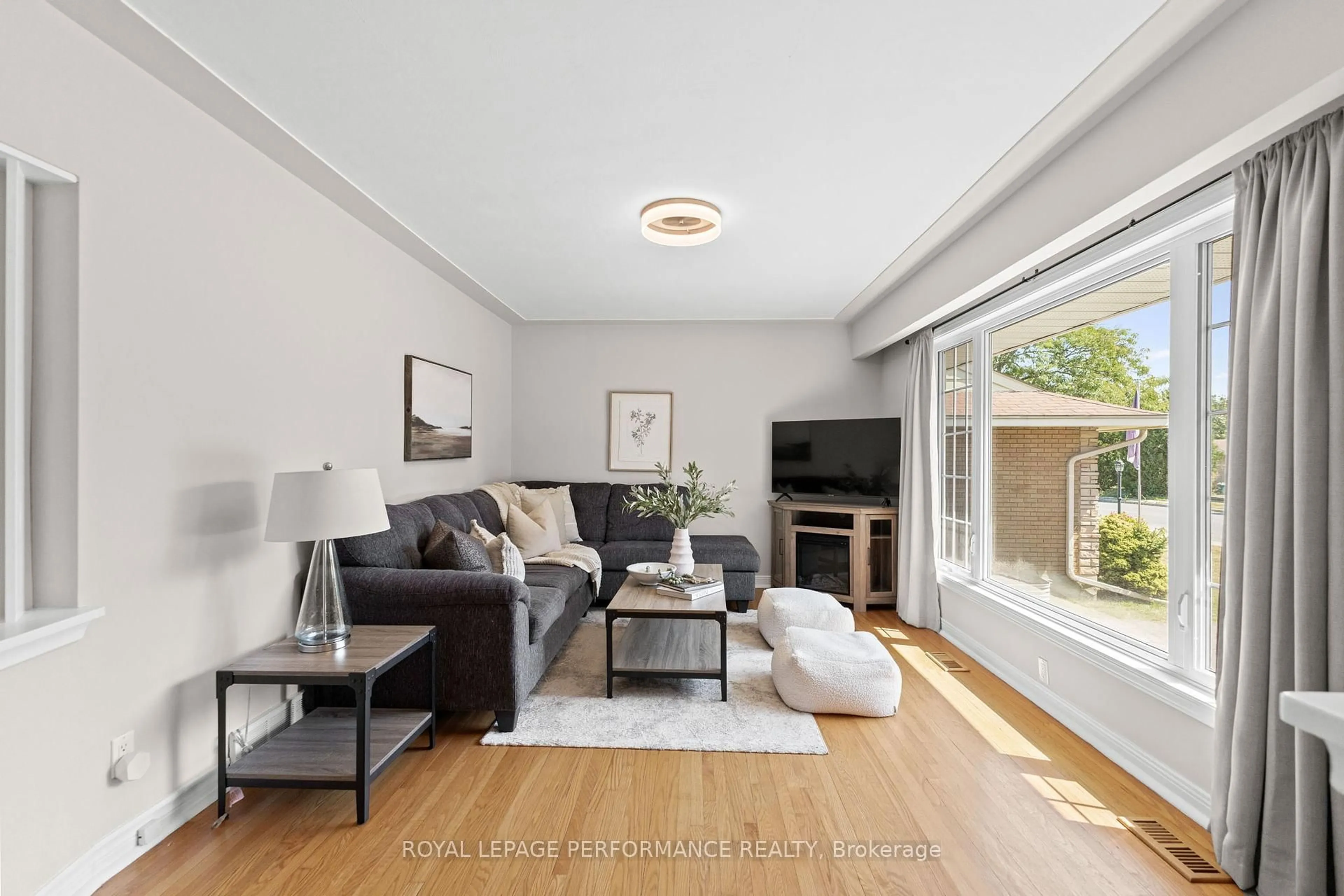 Living room with furniture, wood/laminate floor for 705 Pleasant Park Rd, Ottawa Ontario K1G 1Y3