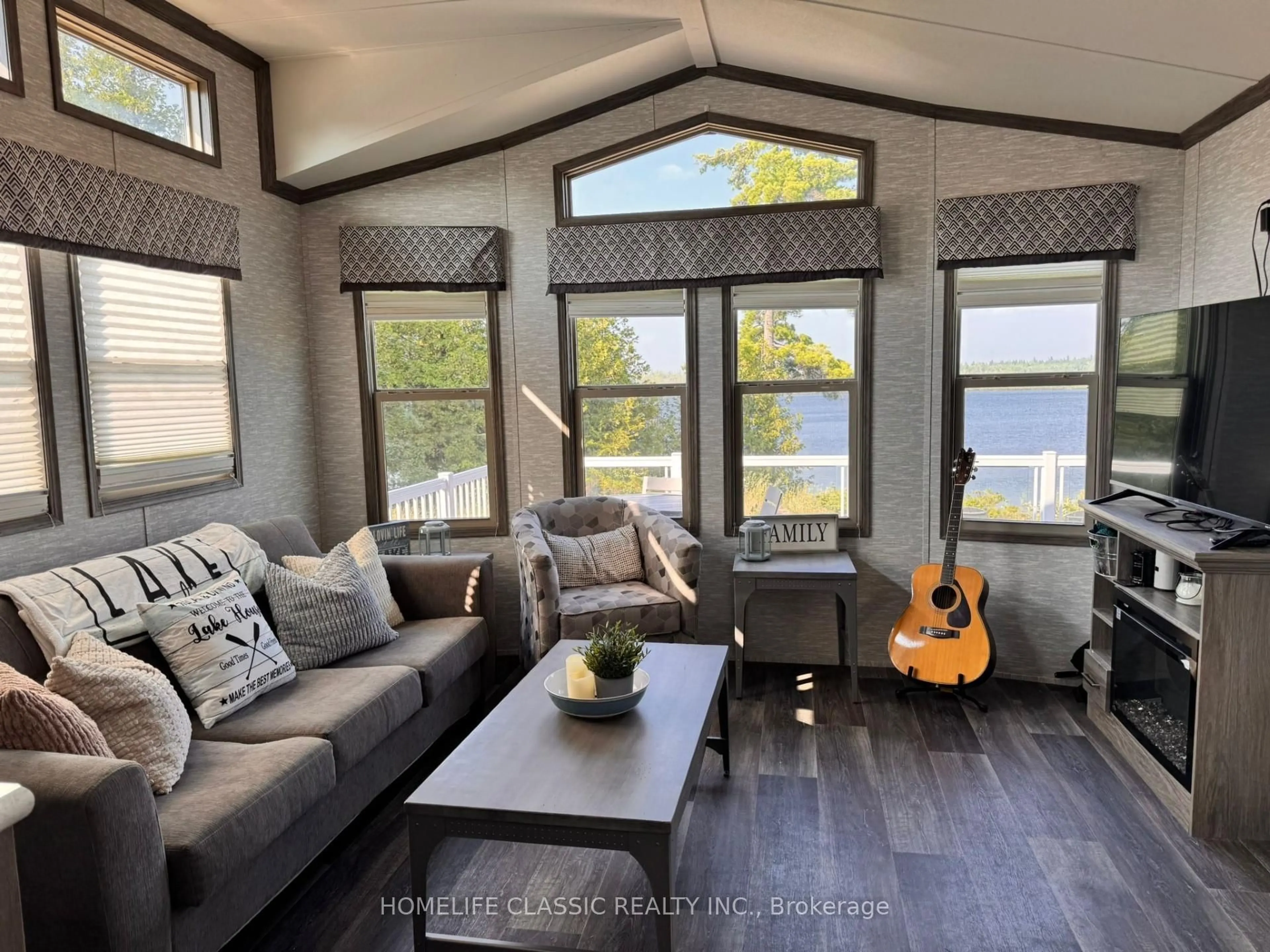 Living room with furniture, wood/laminate floor for 2612 Victoria Rd, Kawartha Lakes Ontario K0M 2B0