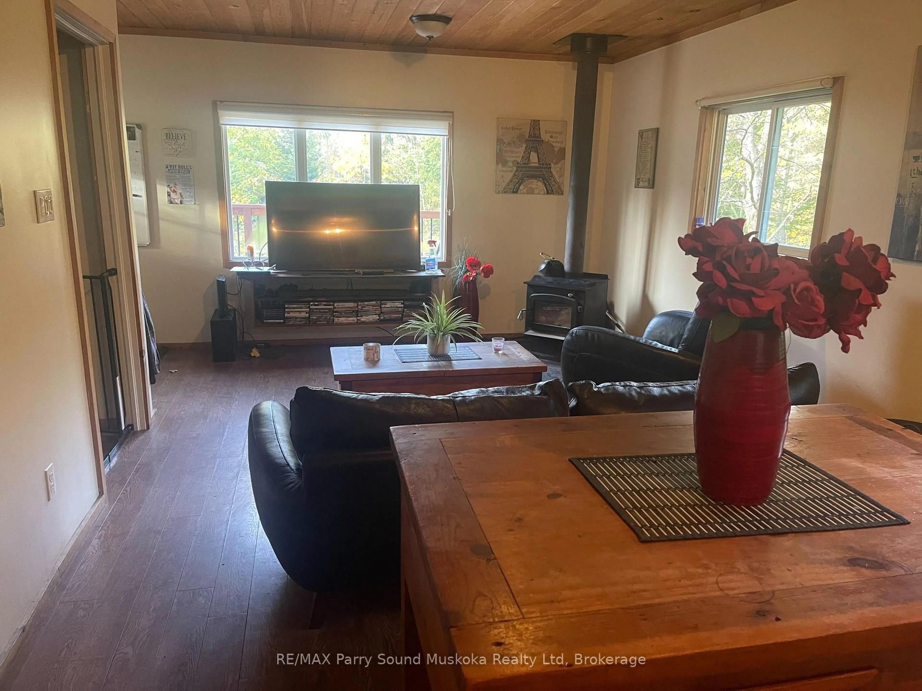 Living room with furniture, wood/laminate floor for 17 Ainslie Lake Rd, Whitestone Ontario P0A 1G0