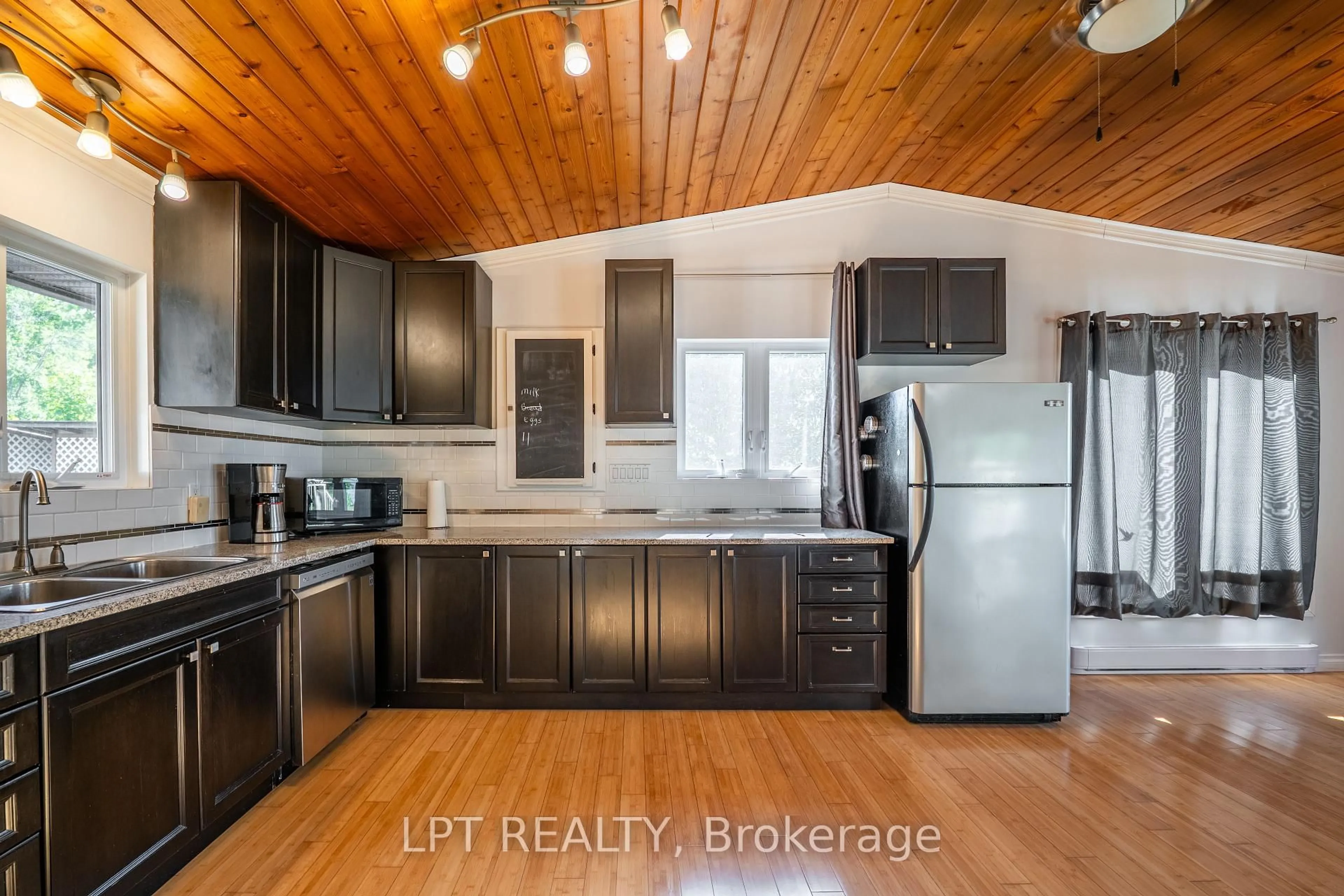 Open concept kitchen, wood/laminate floor for 1847 County Rd 7 Rd, Prince Edward County Ontario K0K 2T0