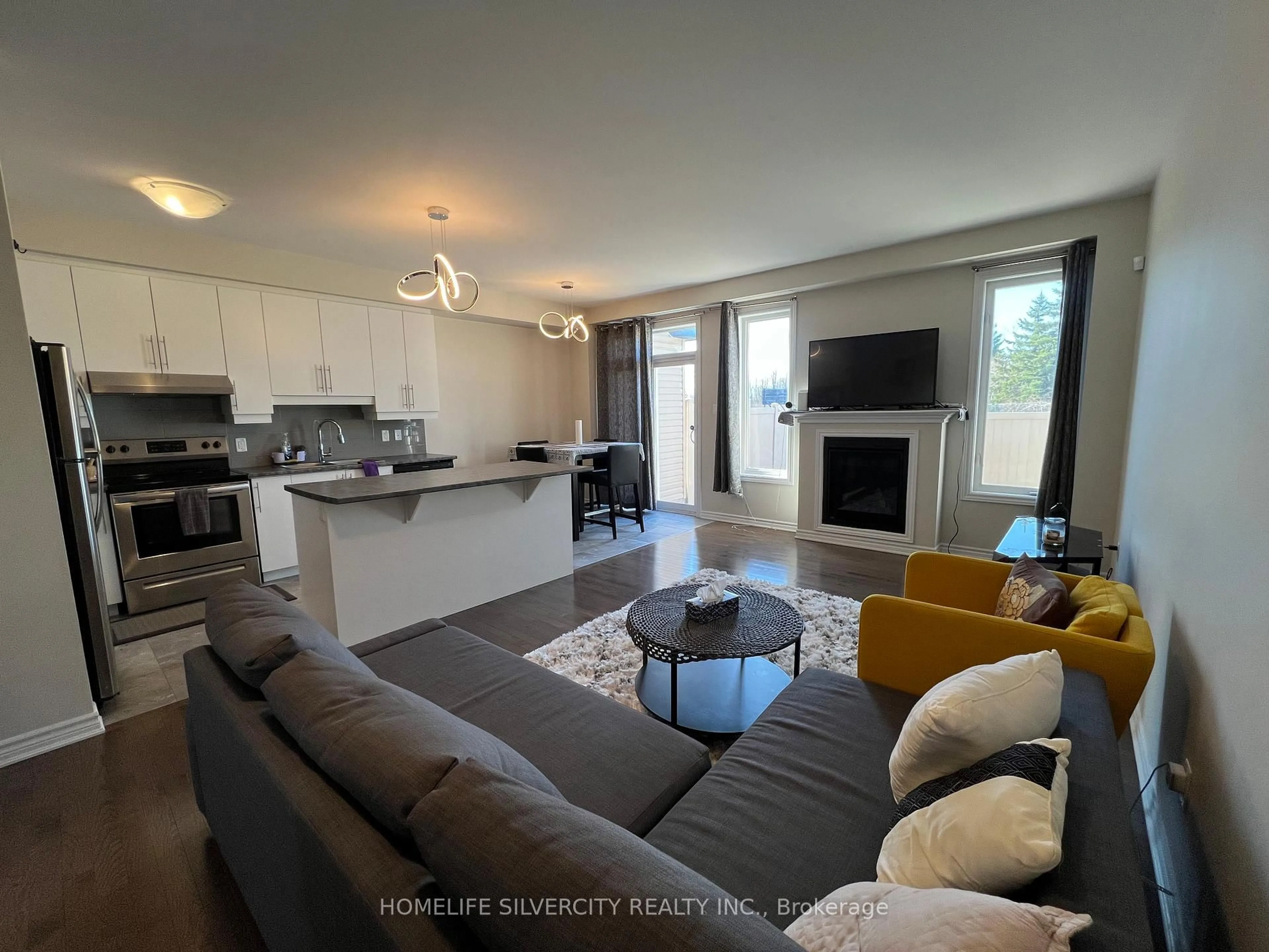 Living room with furniture, wood/laminate floor for 503 Via Mattino Way, Ottawa Ontario K2J 6B7