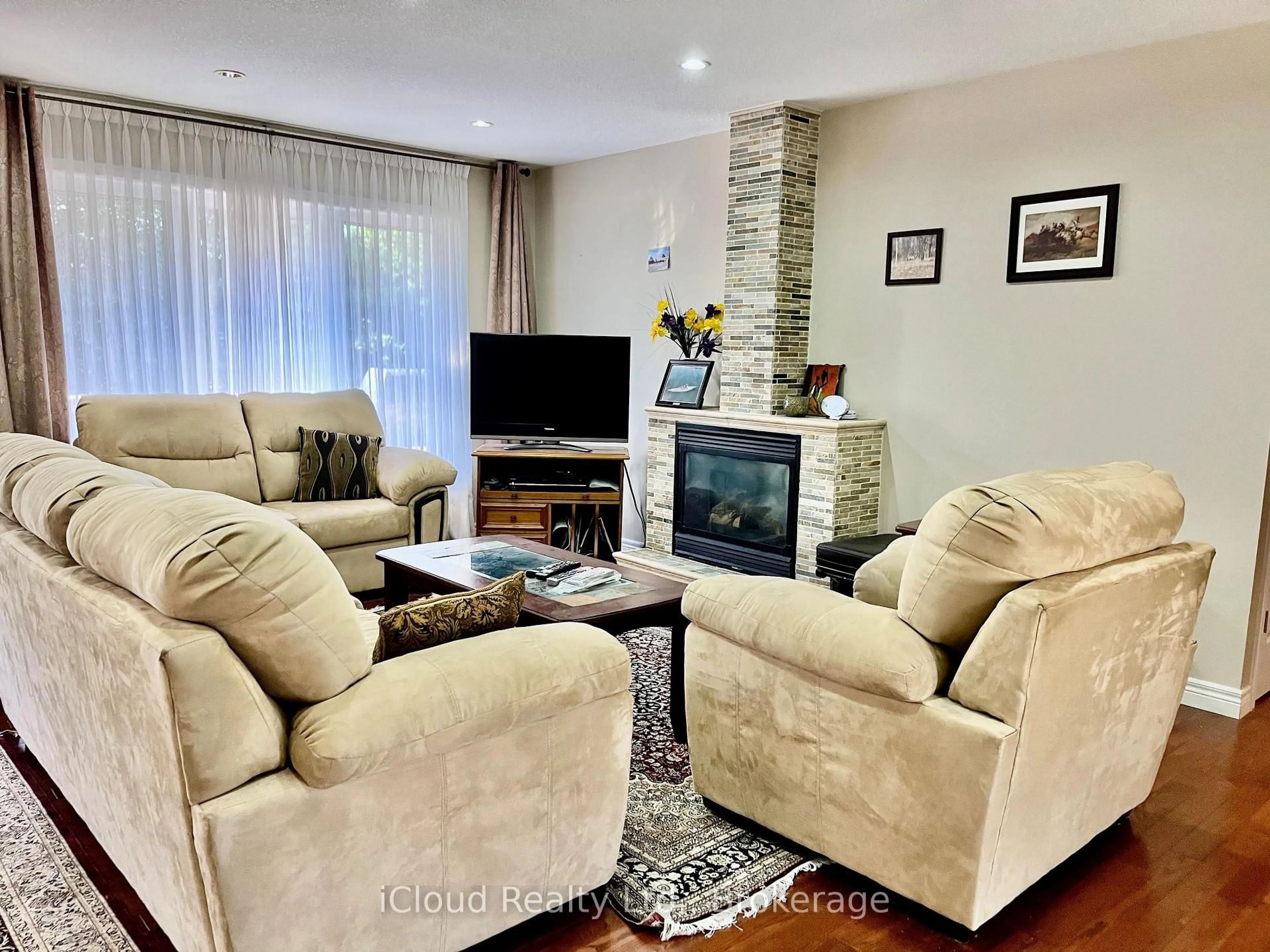 Living room with furniture, wood/laminate floor for 782 Brentwood Dr, Saugeen Shores Ontario N0H 2C4